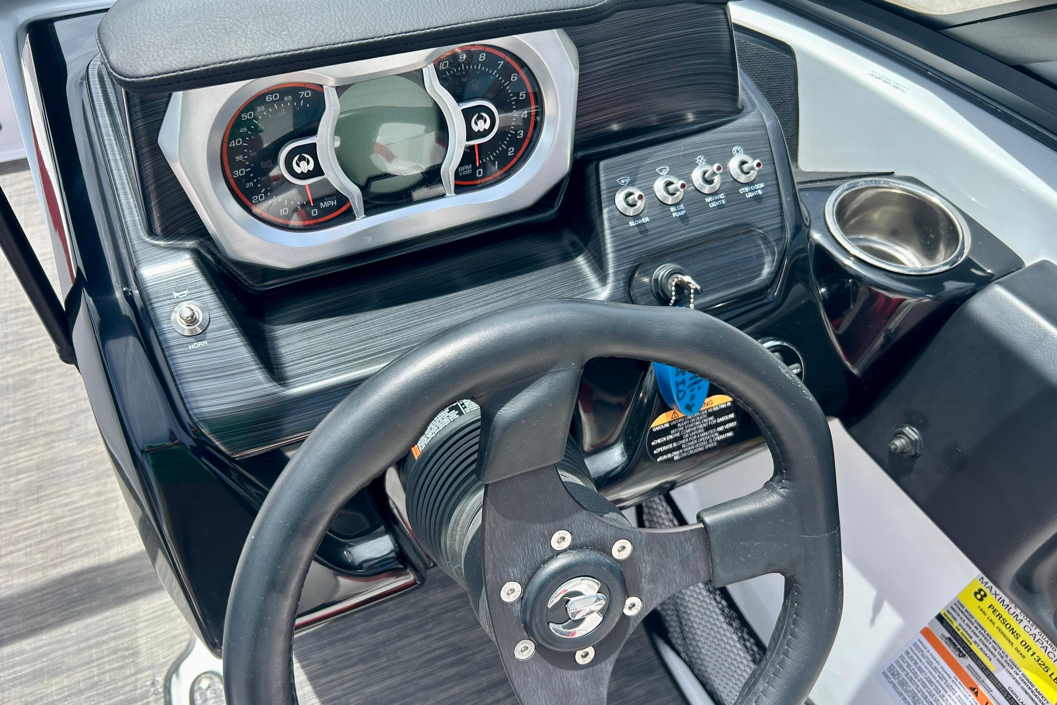 Dashboard of a 2021 Scarab 195 ID boat with steering wheel and controls.