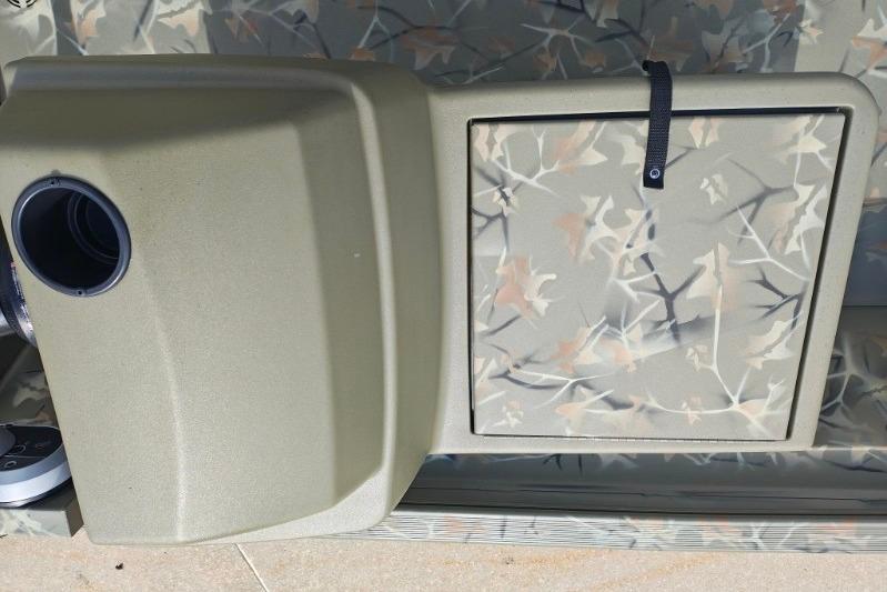 2025 Tracker Grizzly 1648 SC boat with camouflage pattern and storage compartment.