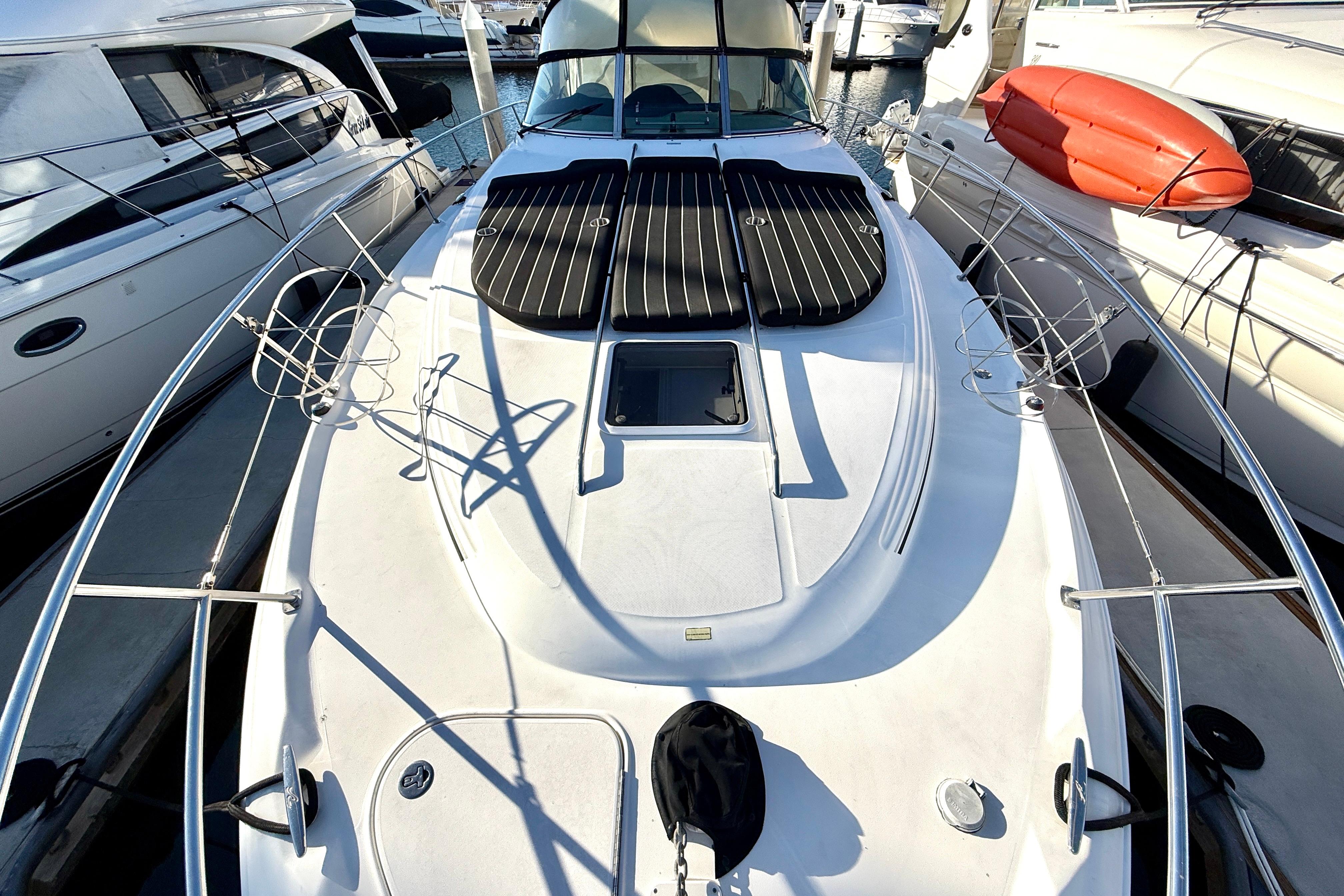 2003 Sea Ray 380 Sundancer yacht docked at marina, featuring spacious deck and sleek design.