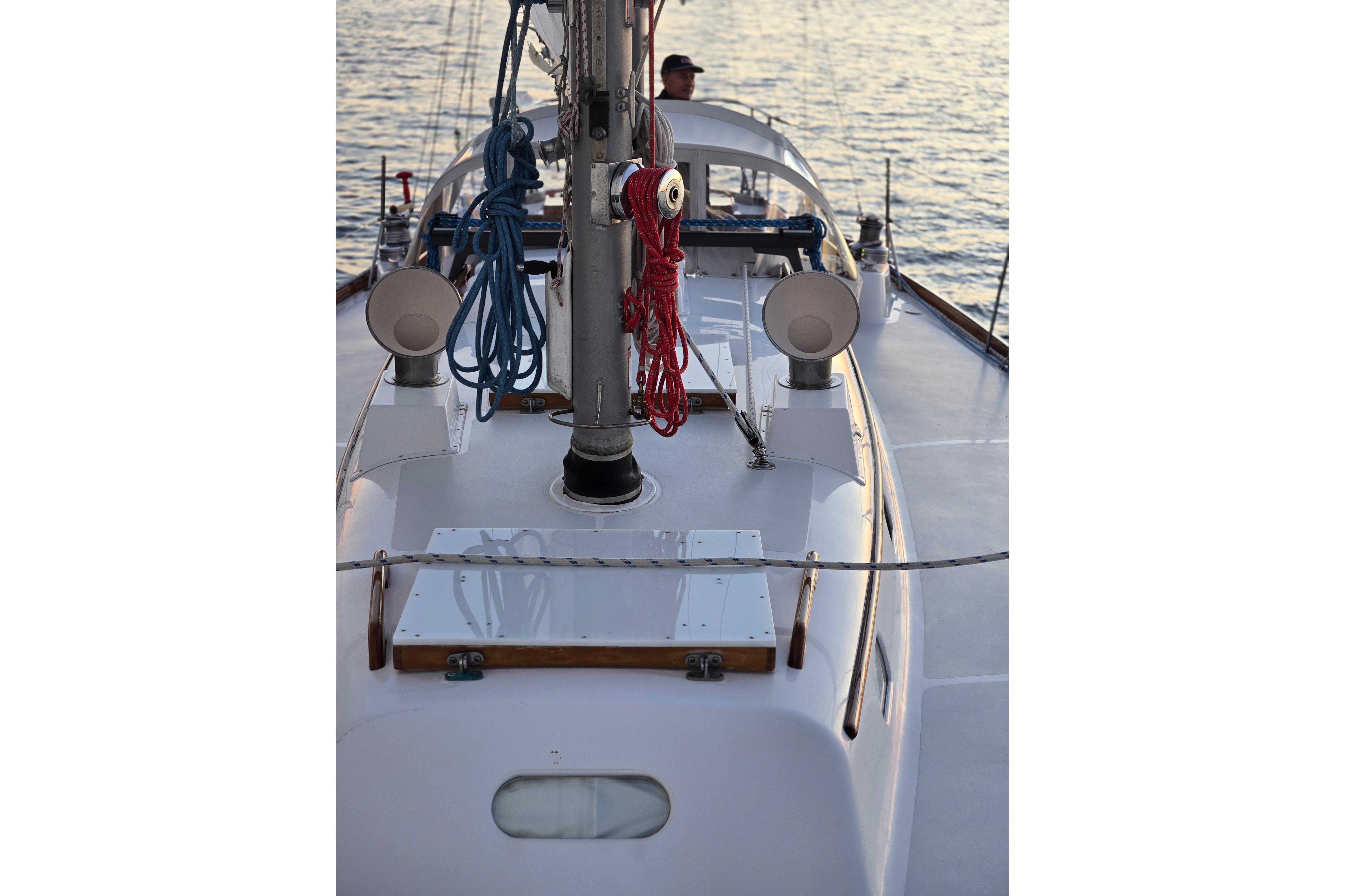 1970 Hinckley Bermuda 40 sailboat deck with ropes and mast, sailing on calm waters.