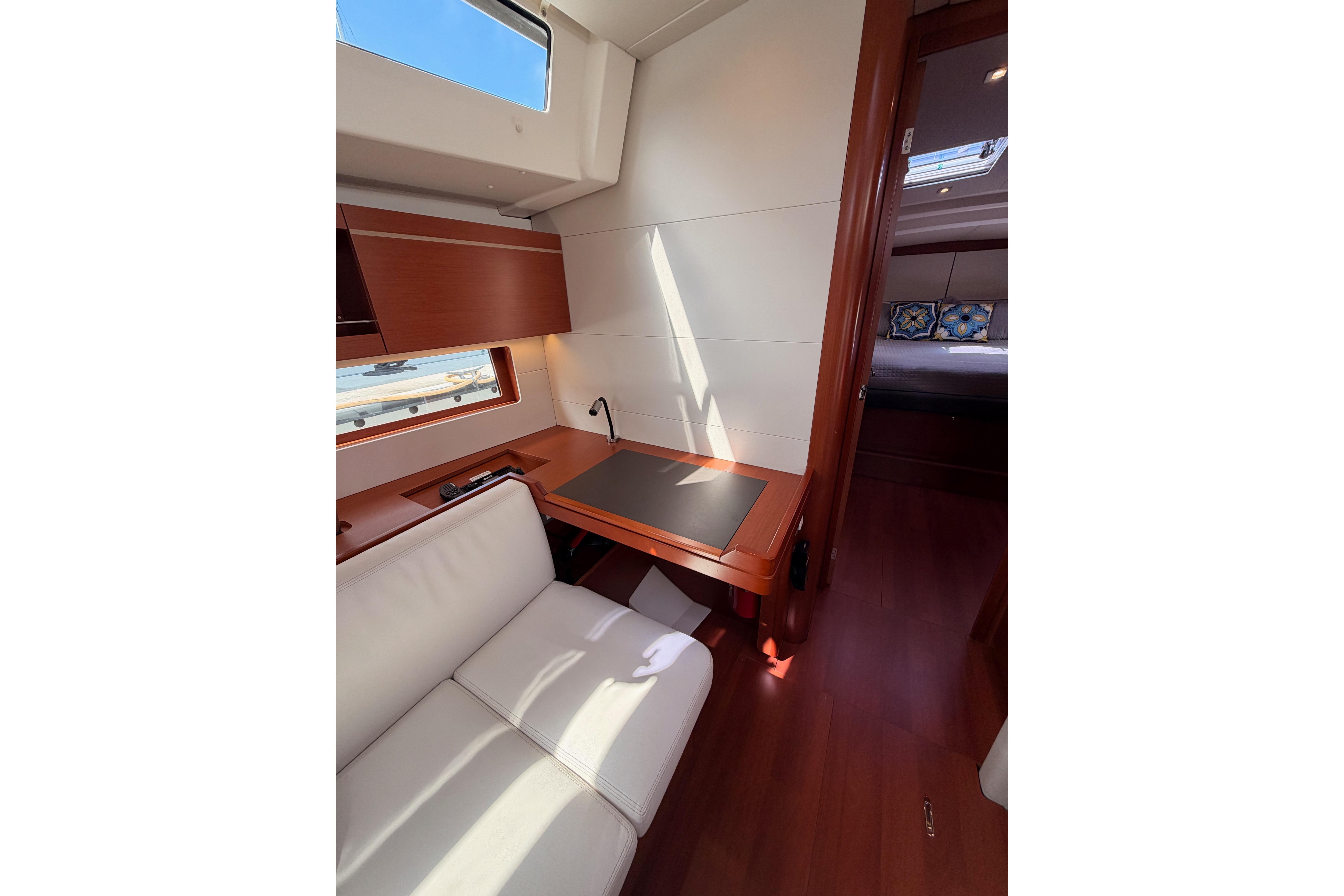 Interior of 2020 Beneteau Oceanis 46.1 yacht, featuring a cozy seating area and desk.