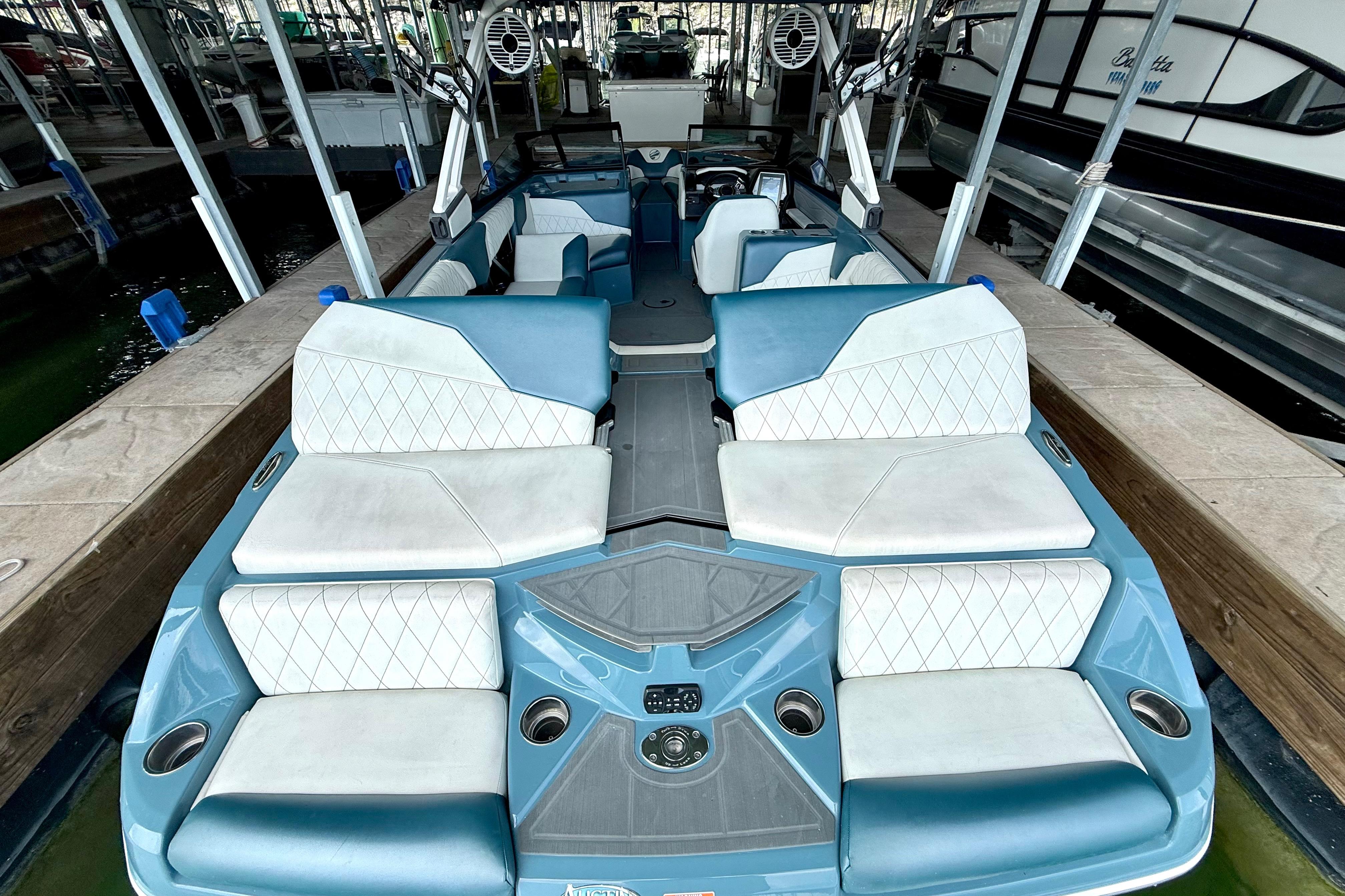 2021 Tige Z3 boat interior with blue and white seating, docked in a marina.