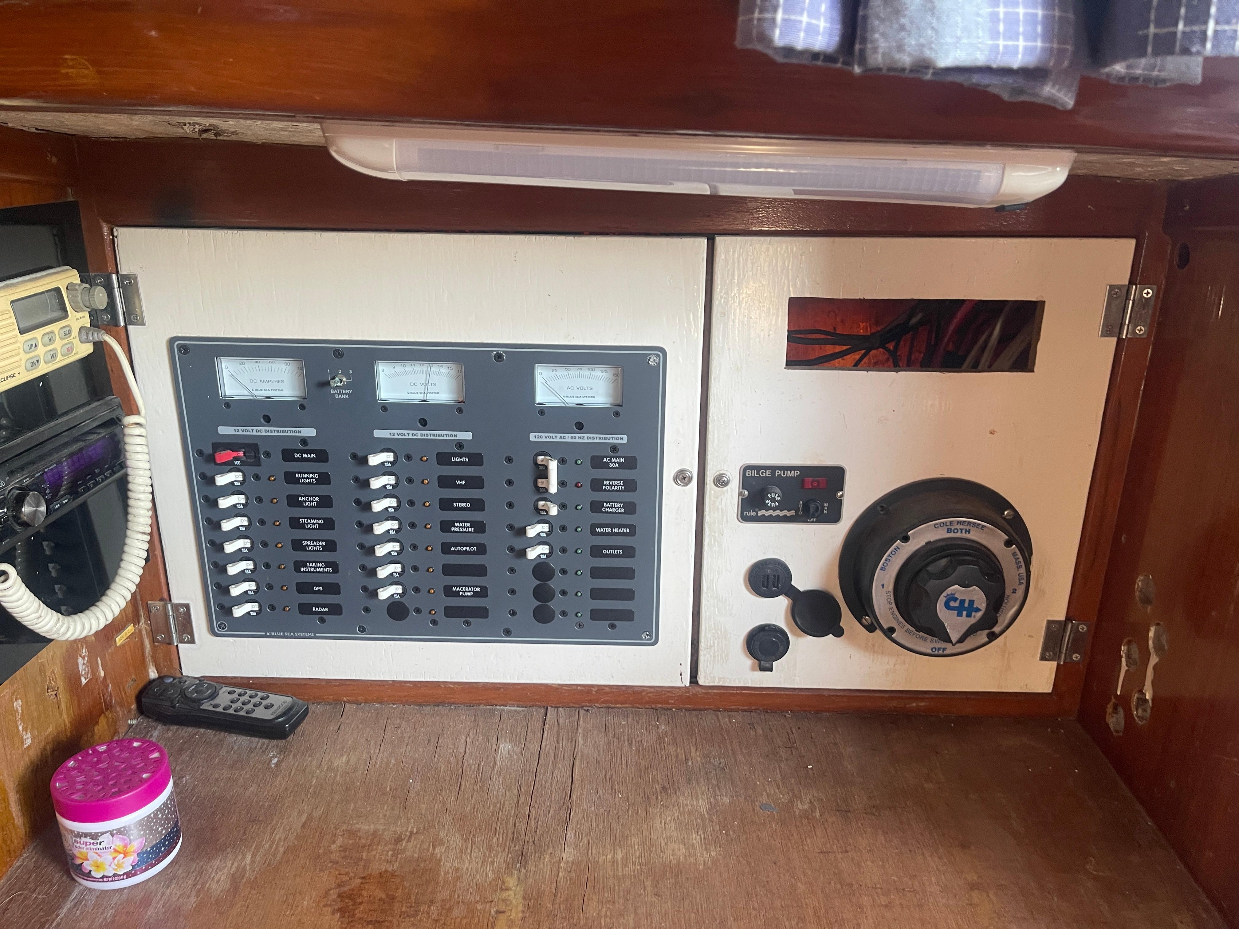 Electrical panel inside a 1976 Cheoy Lee Clipper 42 yacht, featuring gauges and switches.