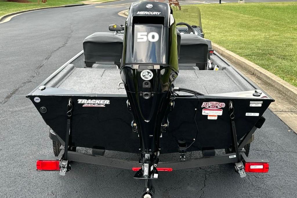 2026 Tracker Bass Tracker Classic XL boat with Mercury 50 engine, parked on asphalt.