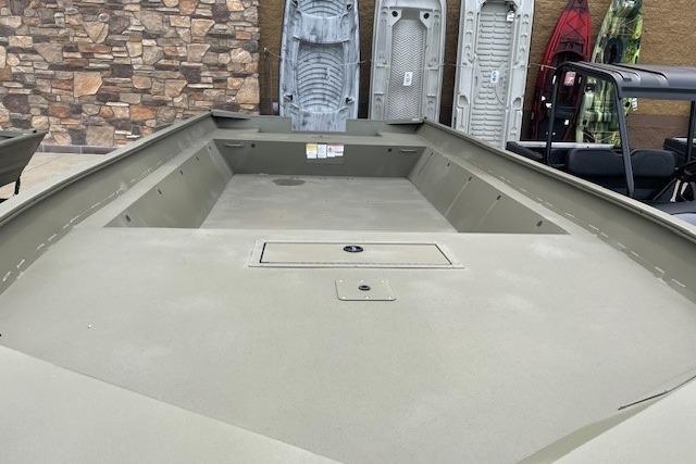 2025 Tracker Grizzly 2072 Utility boat with spacious deck, displayed outdoors.