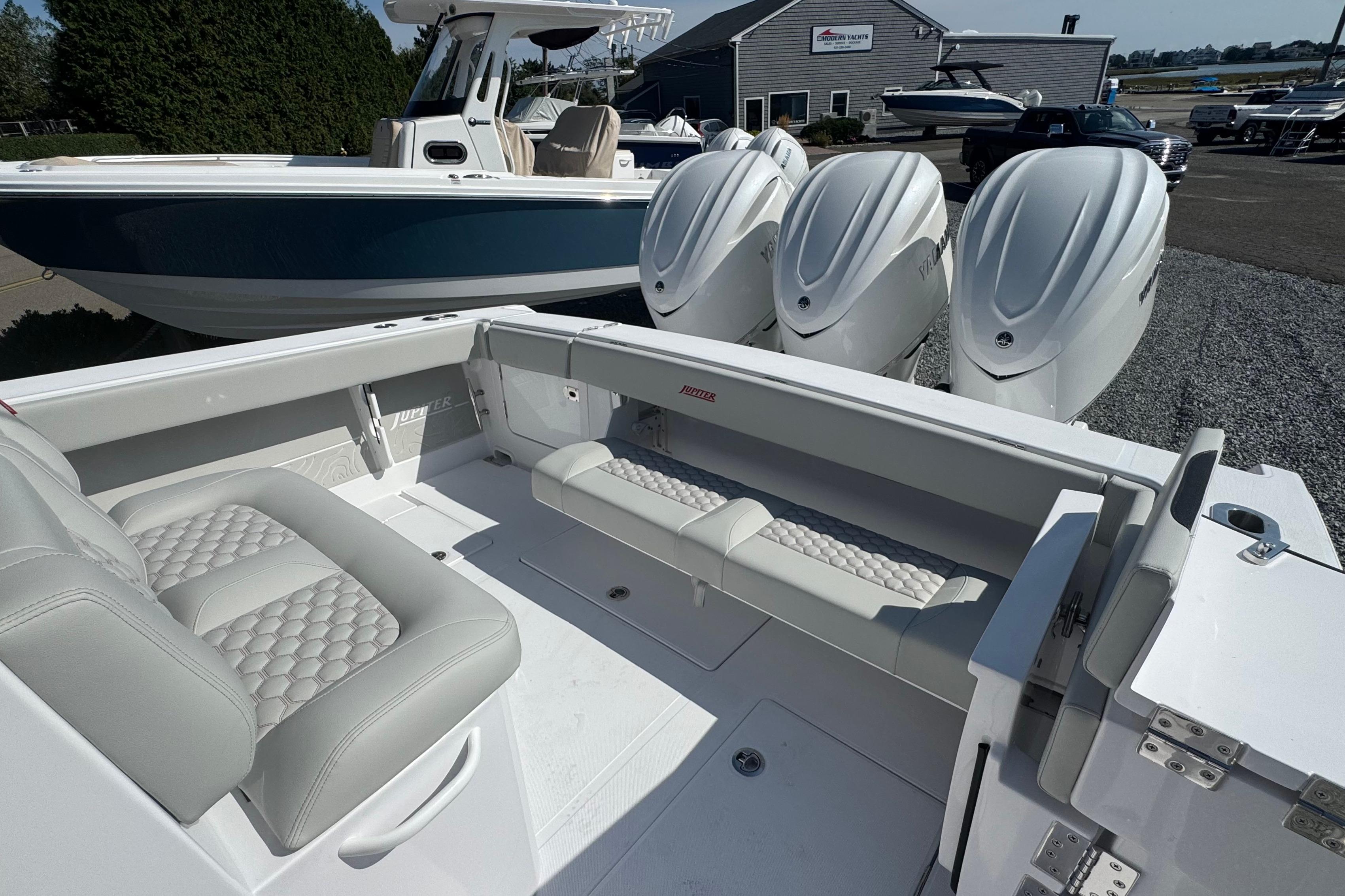 2026 Jupiter 34 boat with luxurious seating and powerful outboard engines.