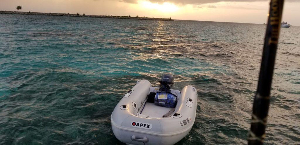 Apex A10 RIB 2022 inflatable boat on turquoise water at sunset.