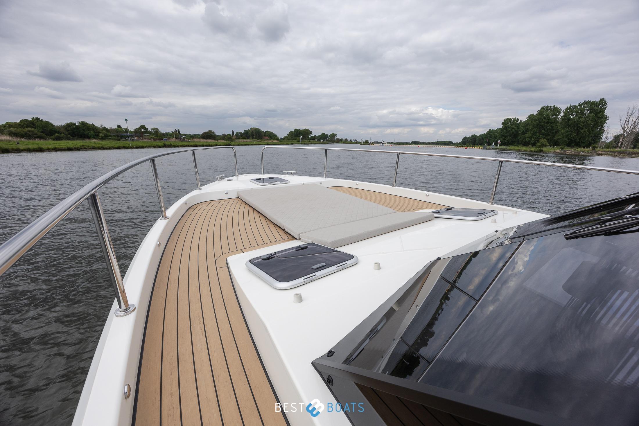 2023 Cobra Yachts Futura 36 Premium Fly on a serene river, showcasing sleek deck design.