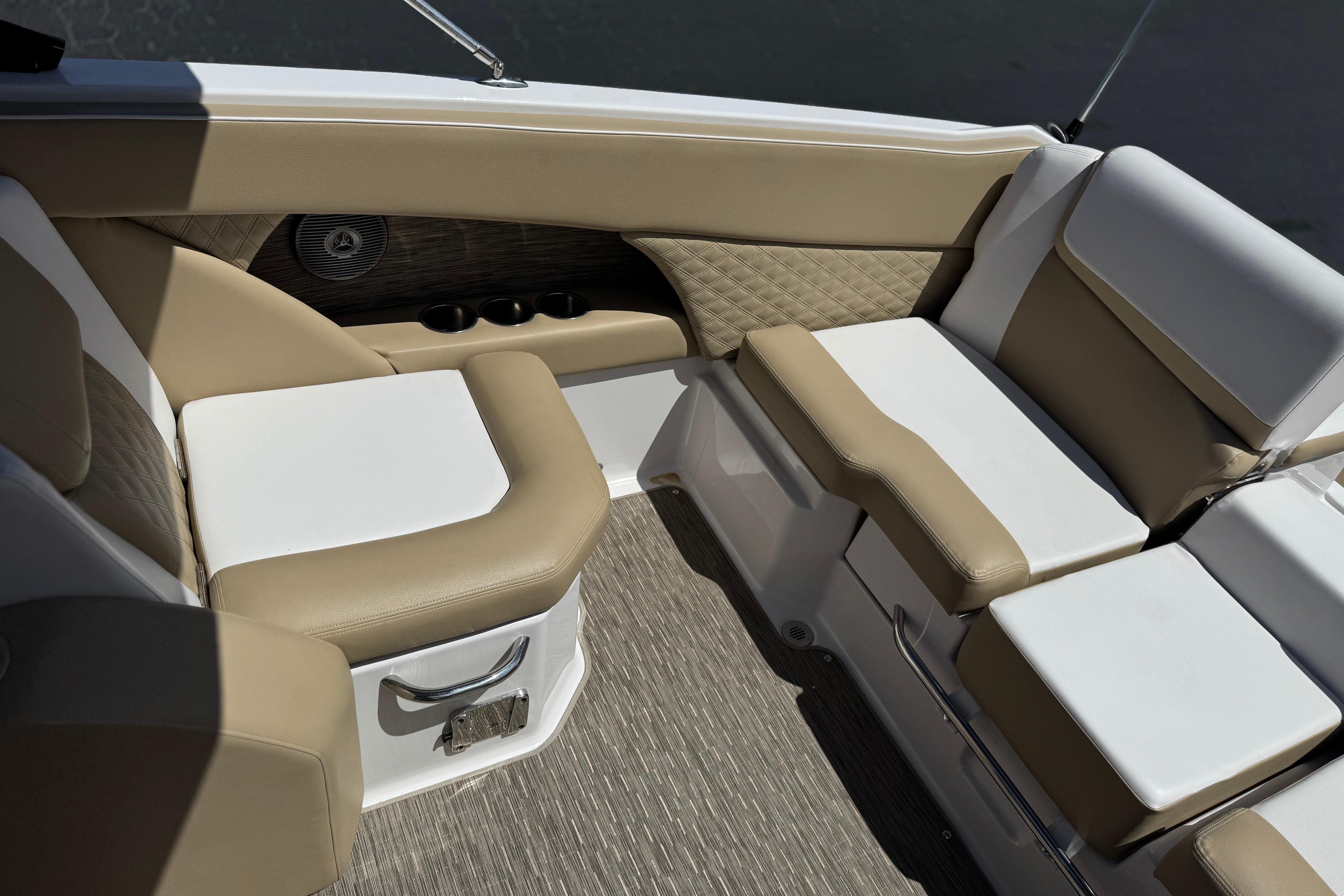 Luxurious seating in 2017 Scarab 255 H.O. Platinum boat with beige and white upholstery.