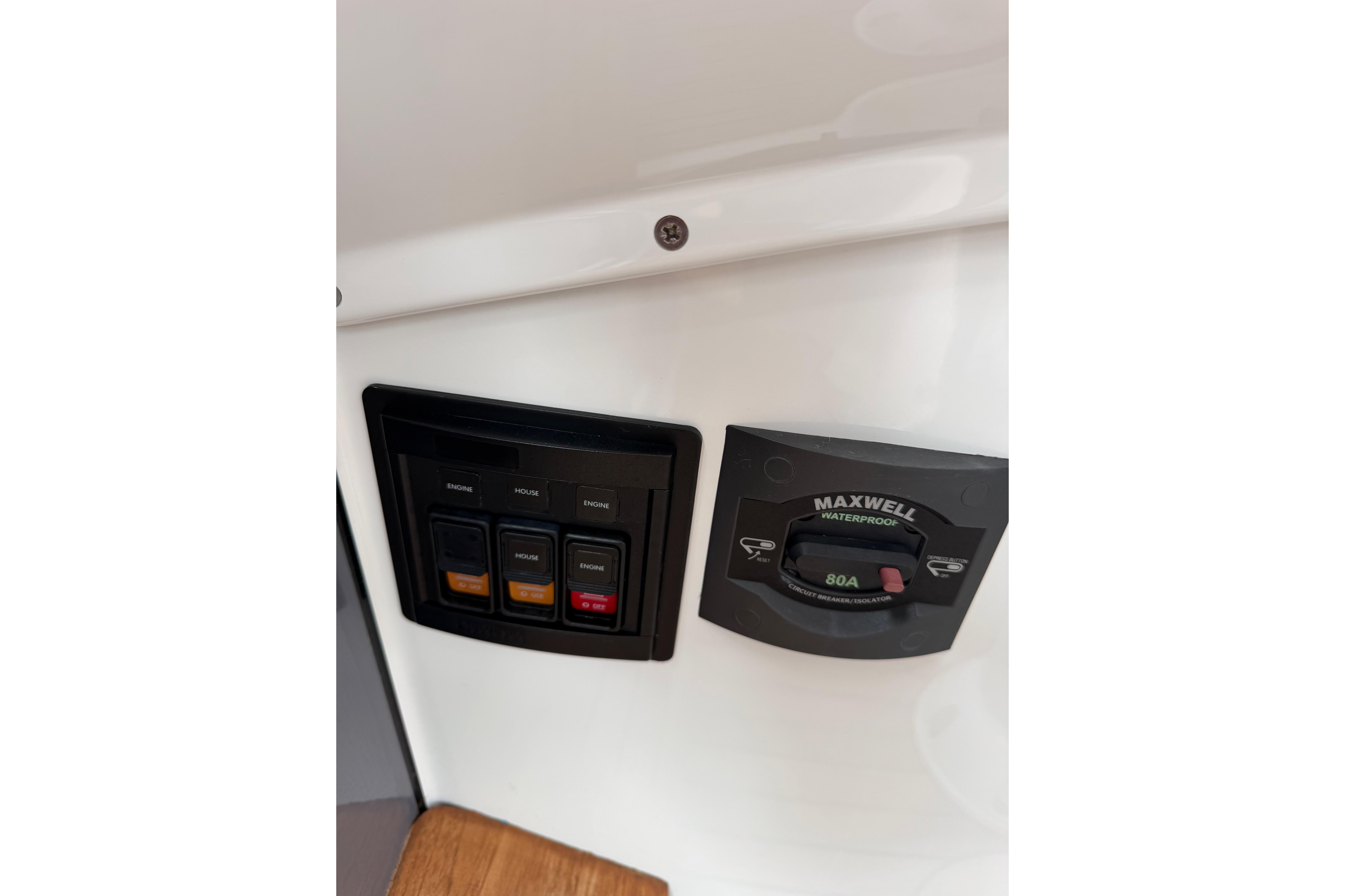 Control panel on a 2016 Protector Targa 30 boat, featuring switches and a Maxwell waterproof circuit breaker.