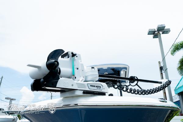 2025 Caymas 281 HB boat with Minn Kota trolling motor, outdoor display.
