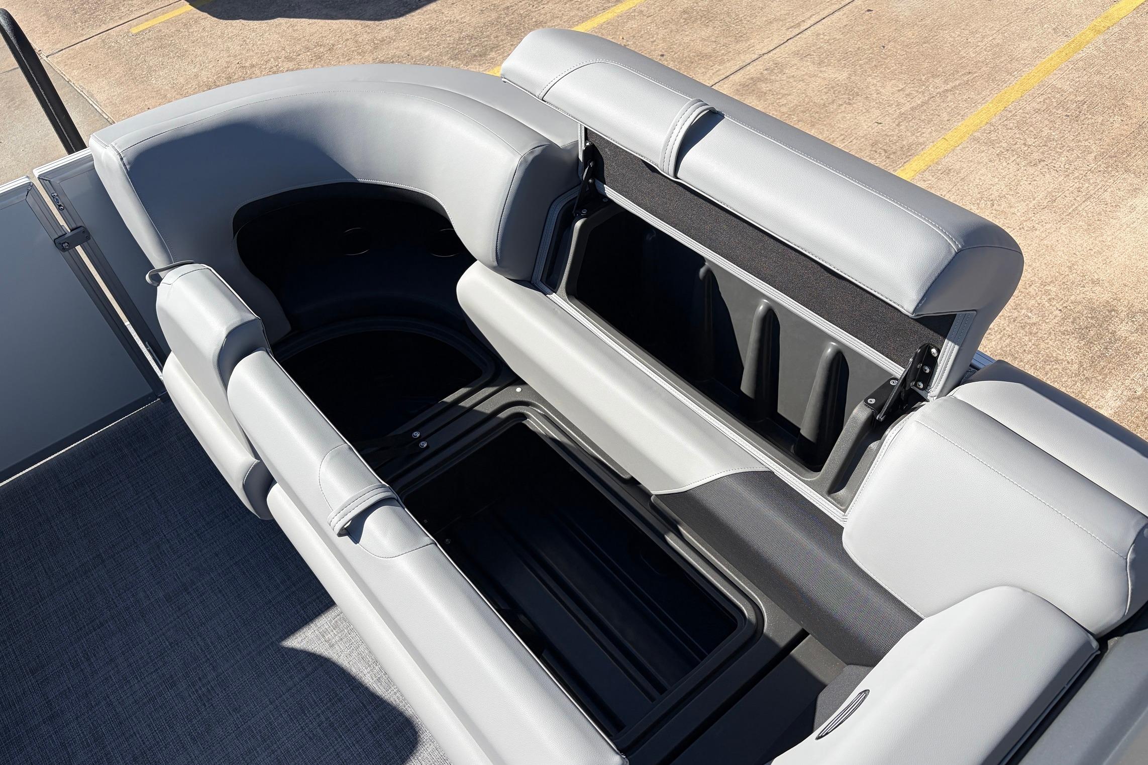 2026 Sun Tracker Party Barge 22 RF XP3 with open storage compartment and gray seating.