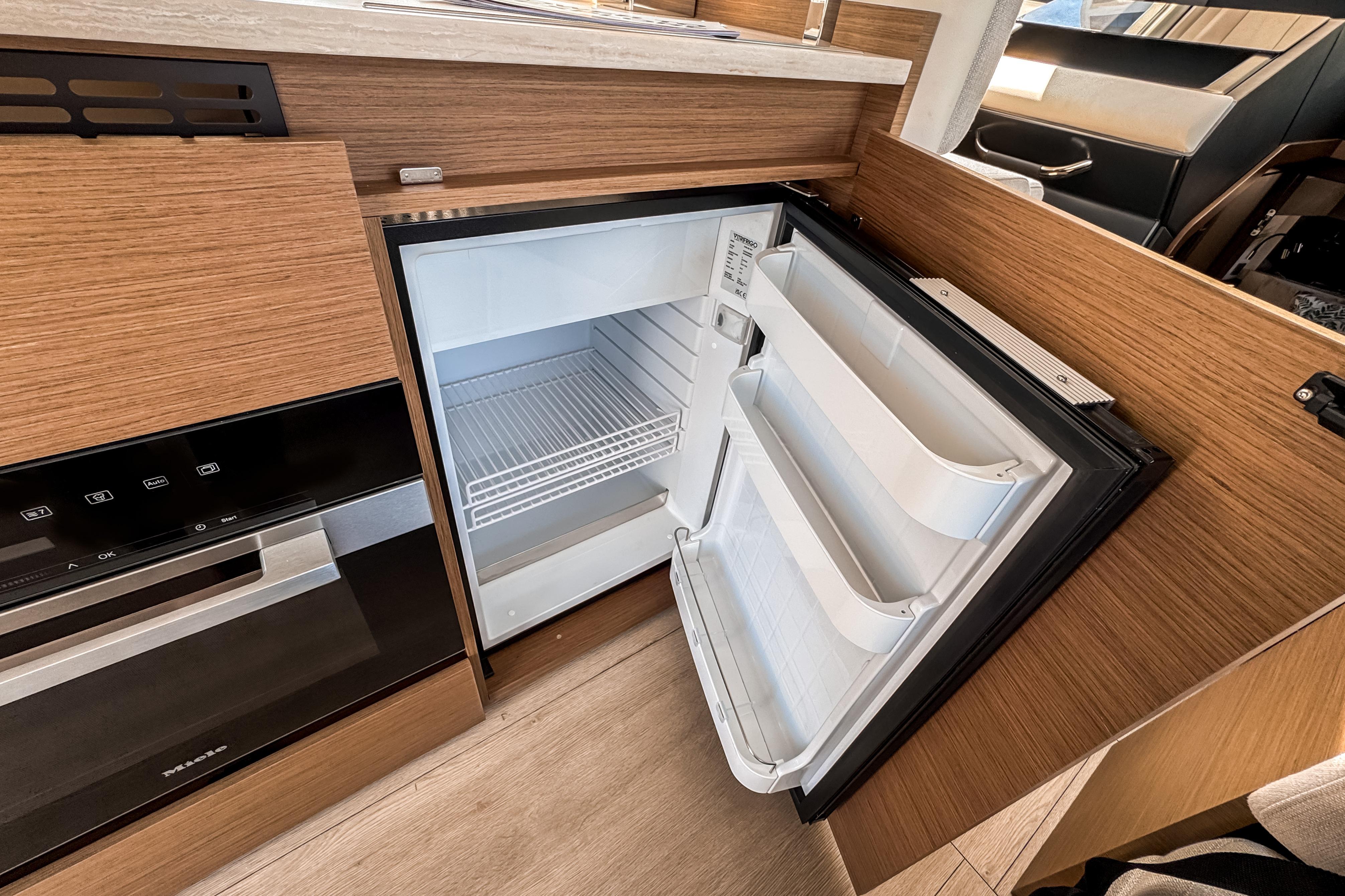 Interior of Wellcraft 44 Explorer 2026 with open refrigerator.