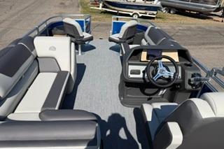 2026 Sun Tracker Fishin' Barge 20 DLX interior with seating and steering console.