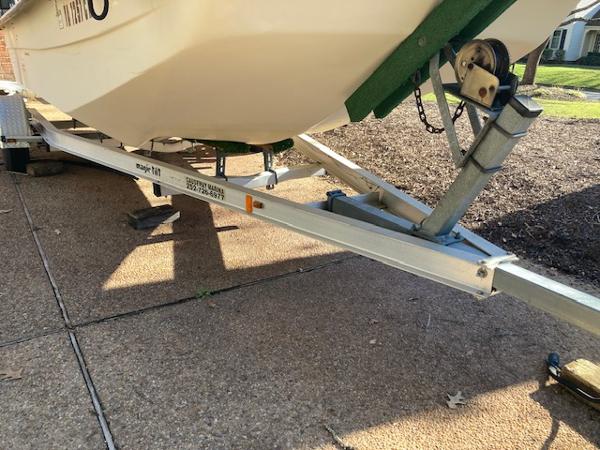 1997 Carolina Skiff 198 DLV on a trailer, parked on a paved surface.