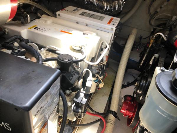 Engine room of a boat with various machinery and cables.