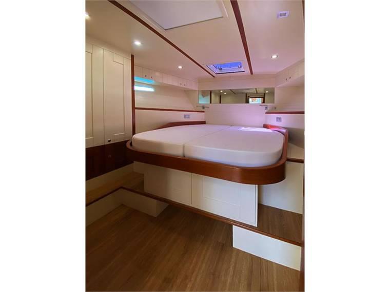 Luxurious cabin interior of 2014 Belliure 50 yacht with elegant wood finish.