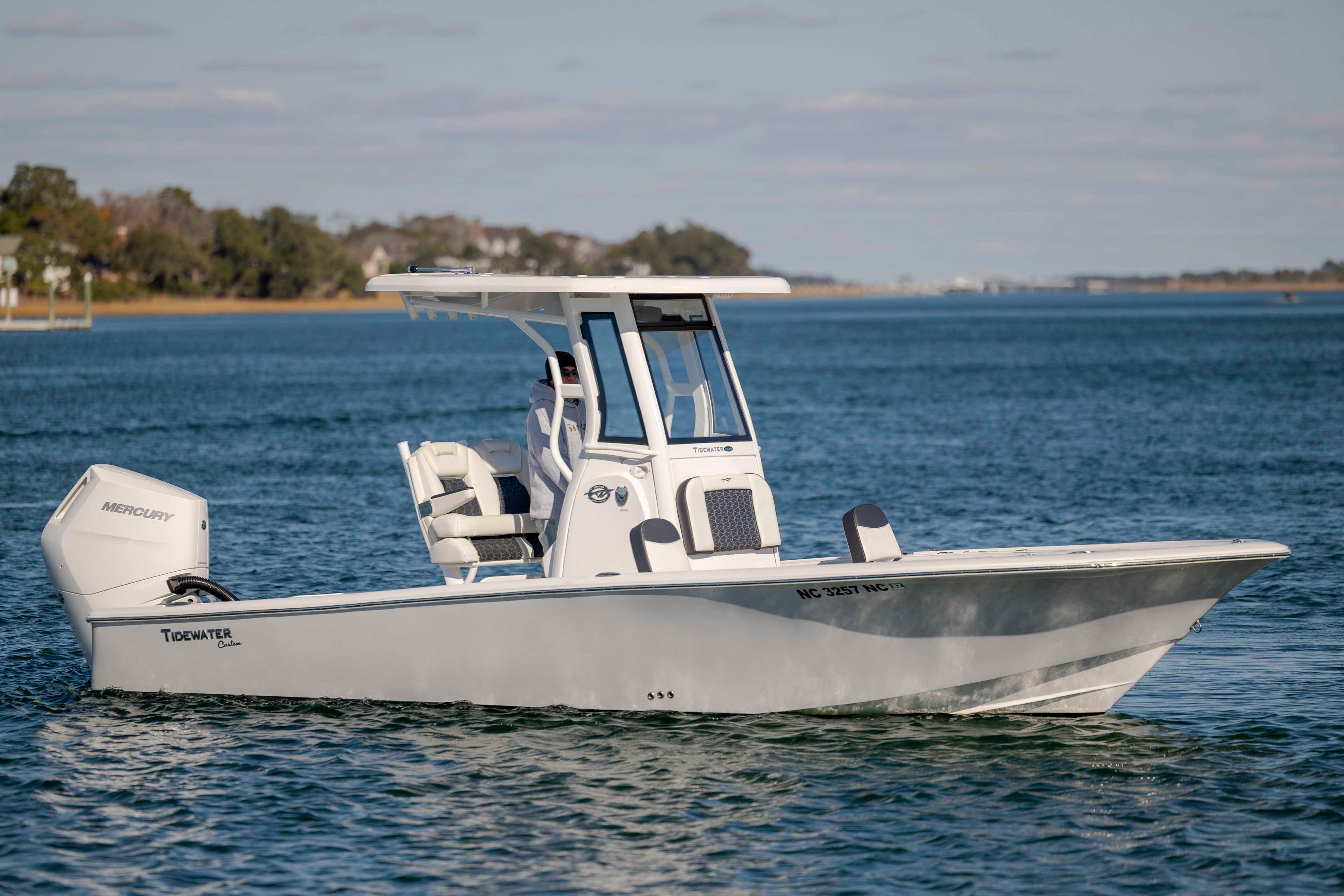 2024 Tidewater 2500 Carolina Bay boat cruising on a calm lake.