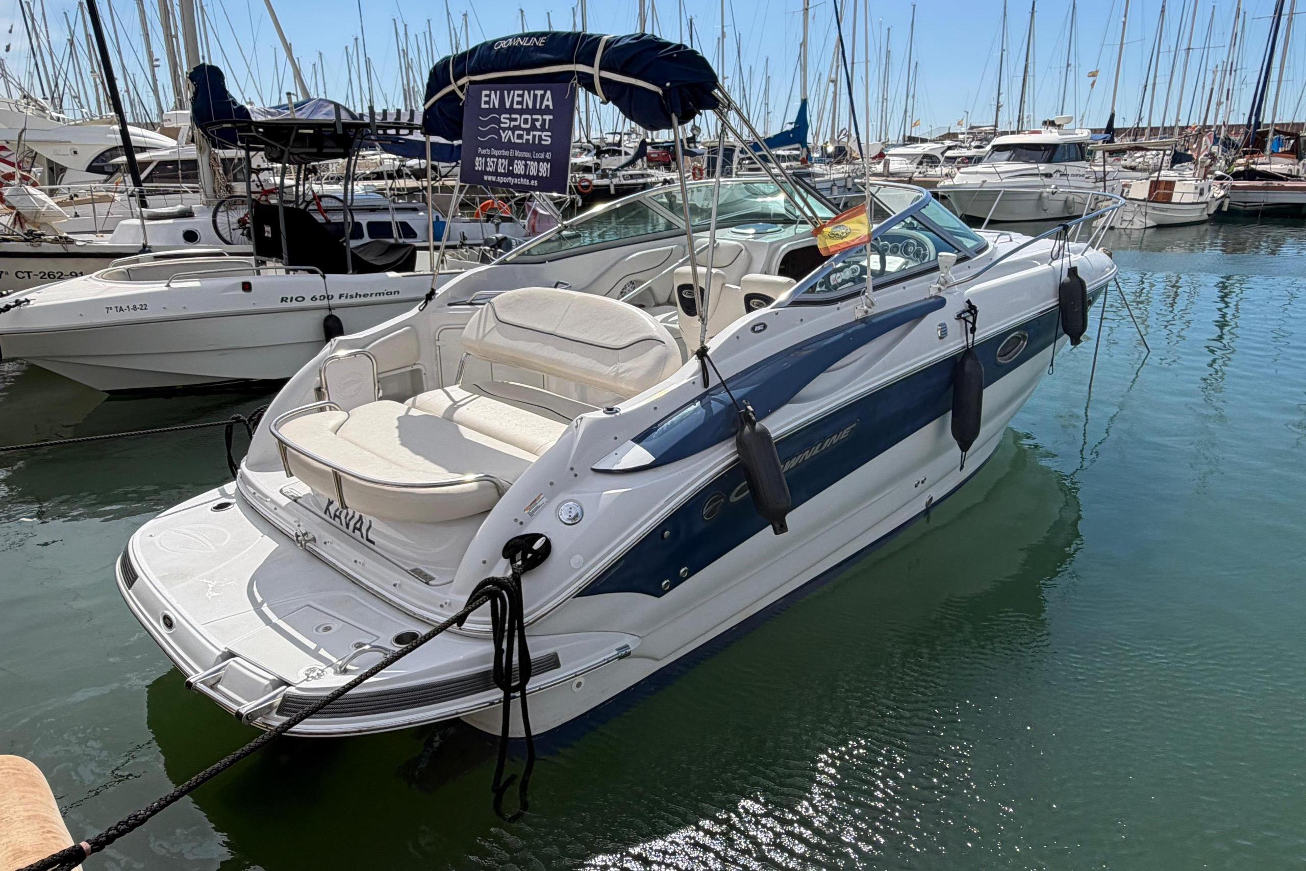 2007 Crownline 250 CR boat docked in a marina, surrounded by other vessels.