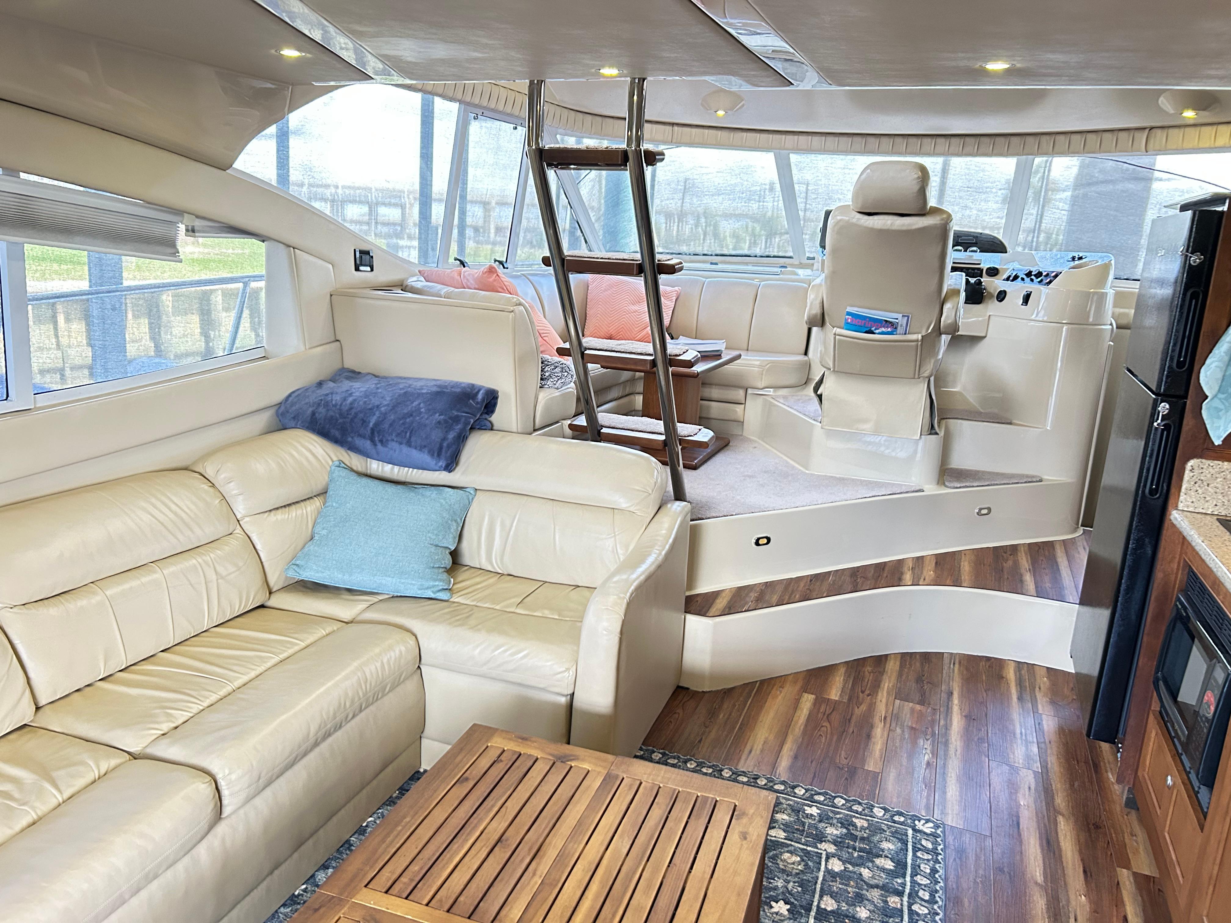 Luxurious interior of 2004 Cruisers Yachts 5000 Sedan Sport with leather seating and wood accents.