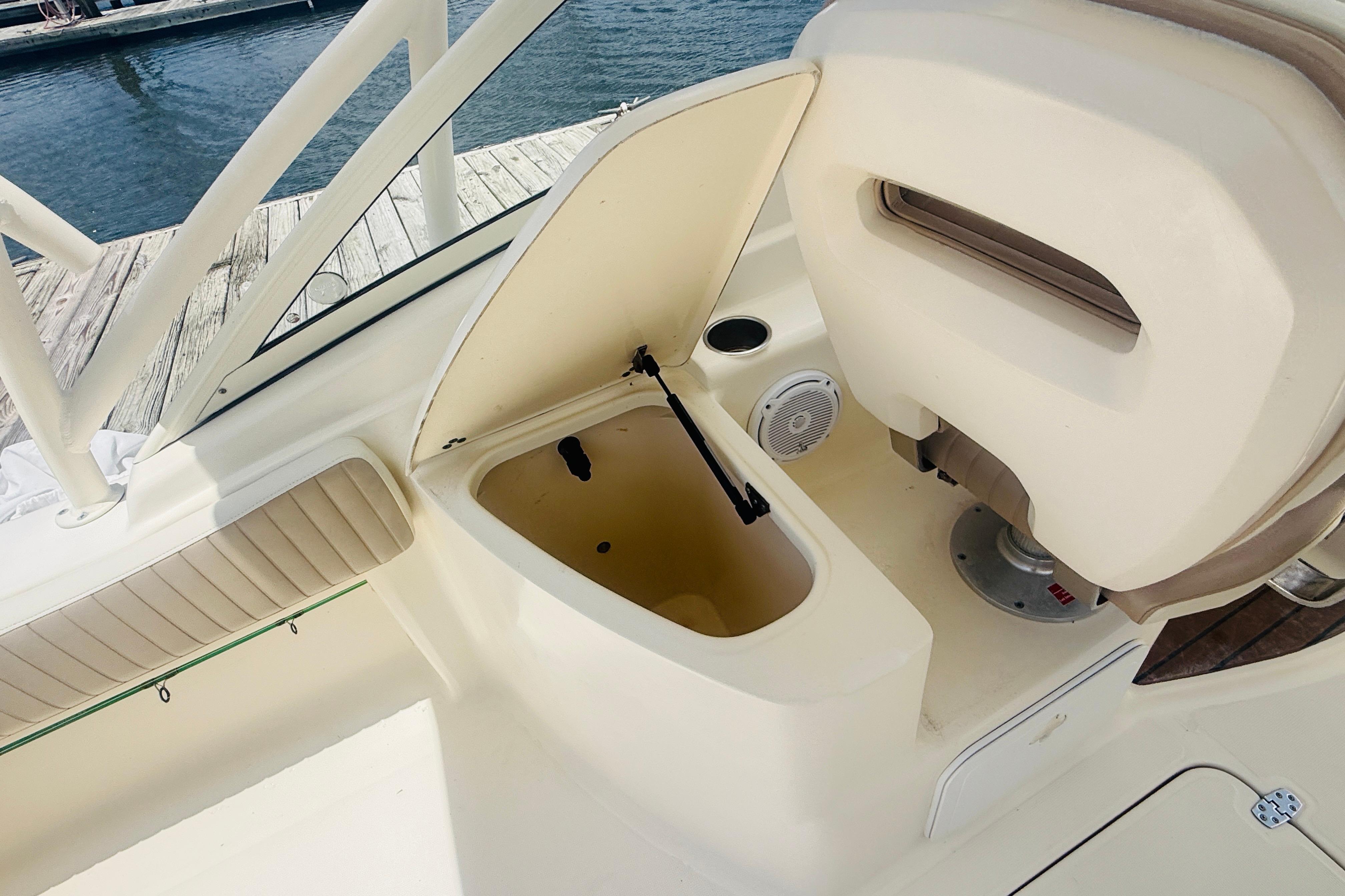 2012 Scout 245 Dorado boat interior with open storage compartment at dock.