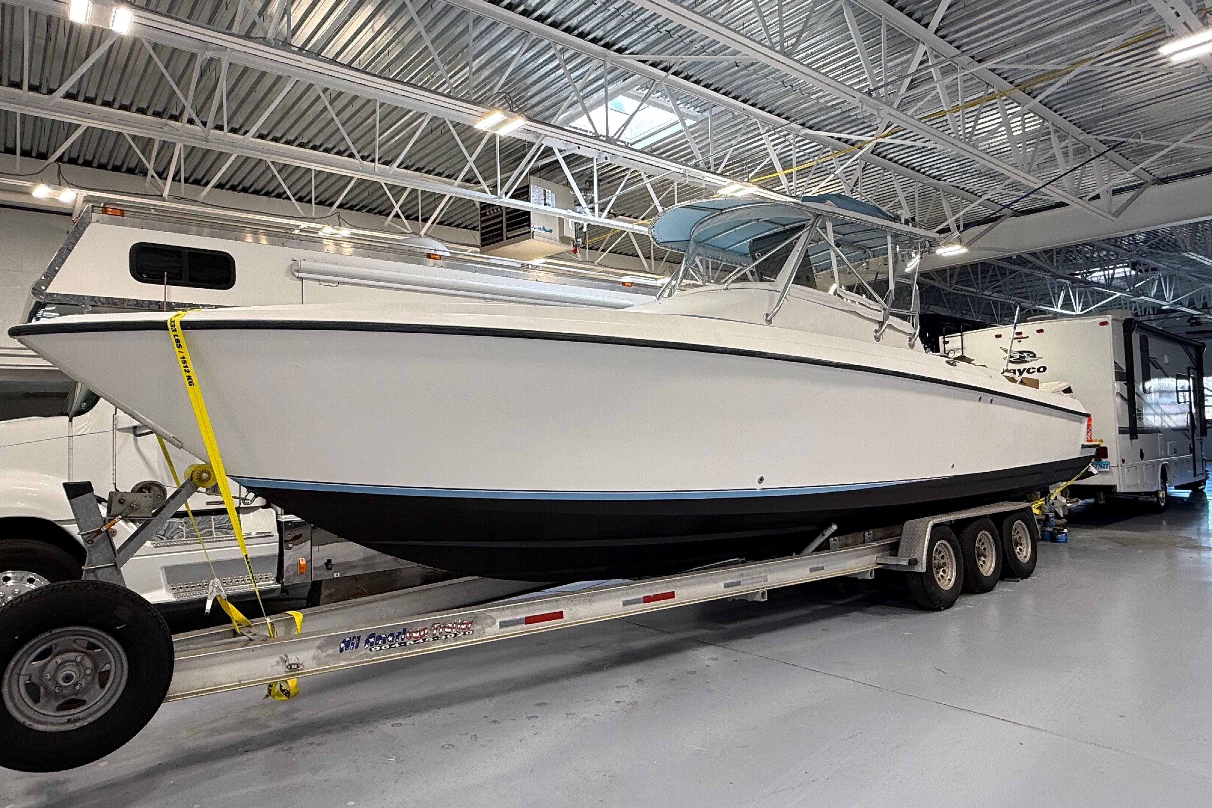 2006 Contender 36 Fisharound boat on trailer in indoor storage facility.