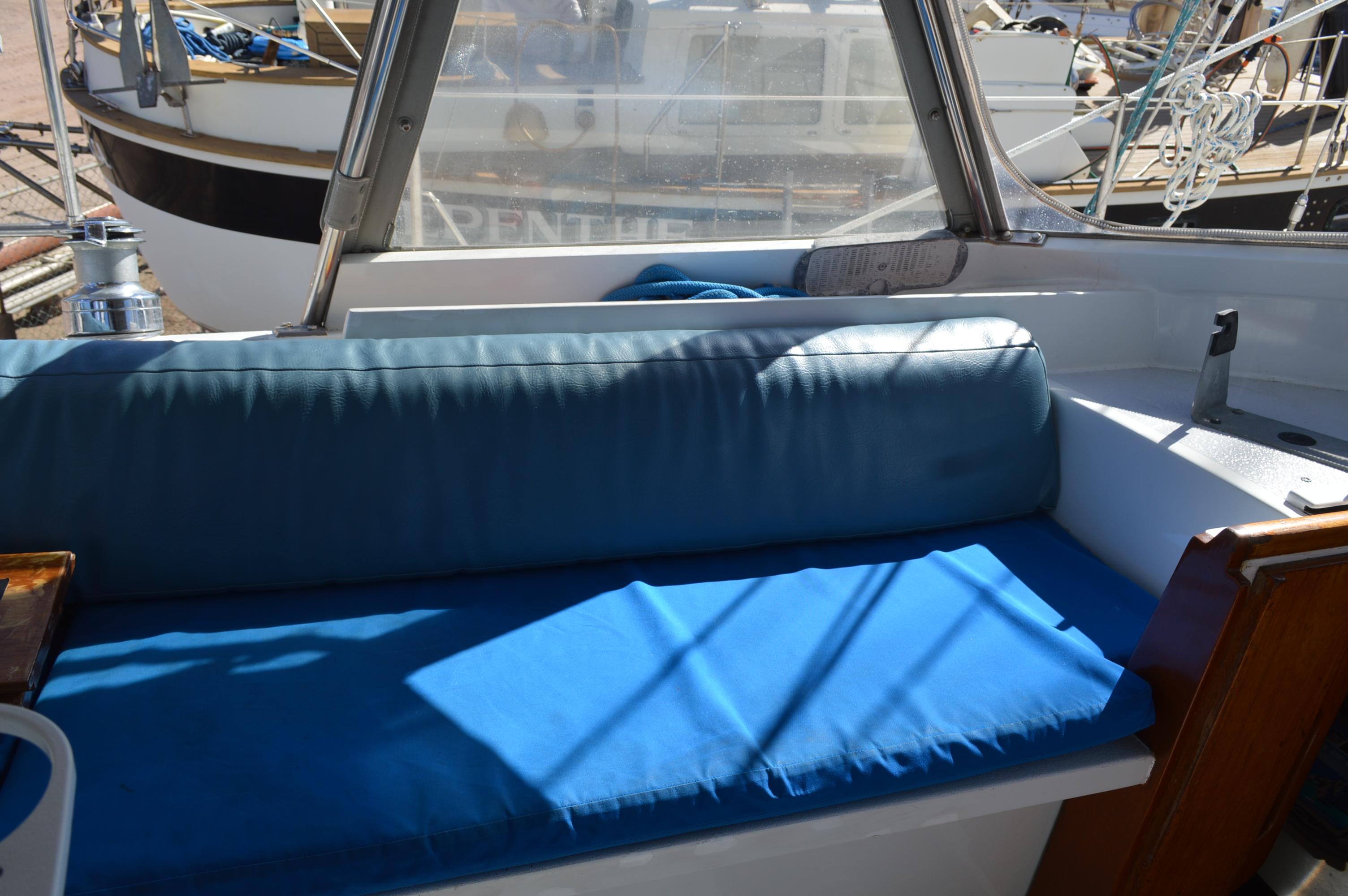 1979 Morgan 461 sailboat interior with blue cushioned seating.