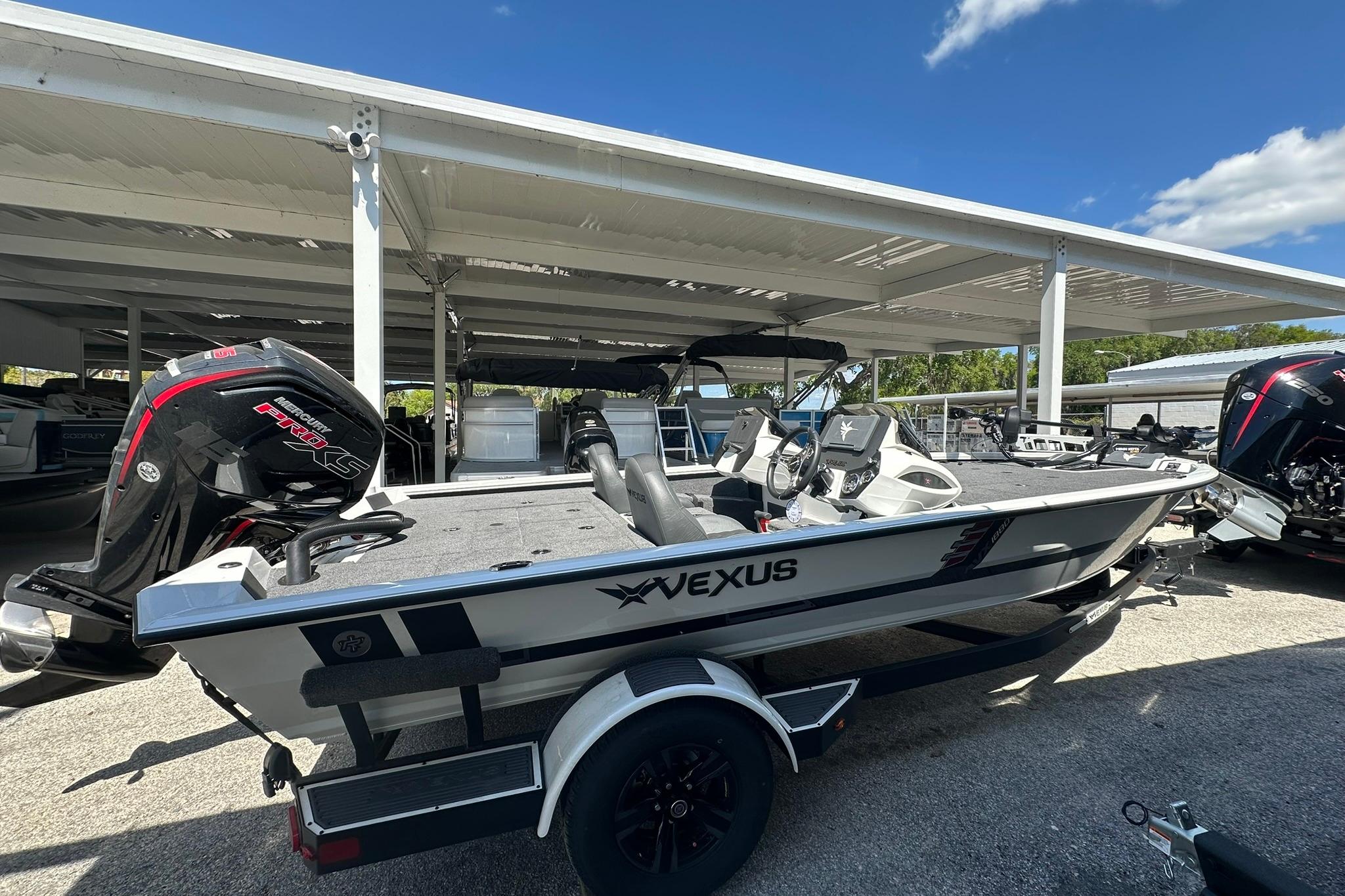 2026 Vexus AVX1880 boat with Mercury Pro XS engine, parked under a canopy.