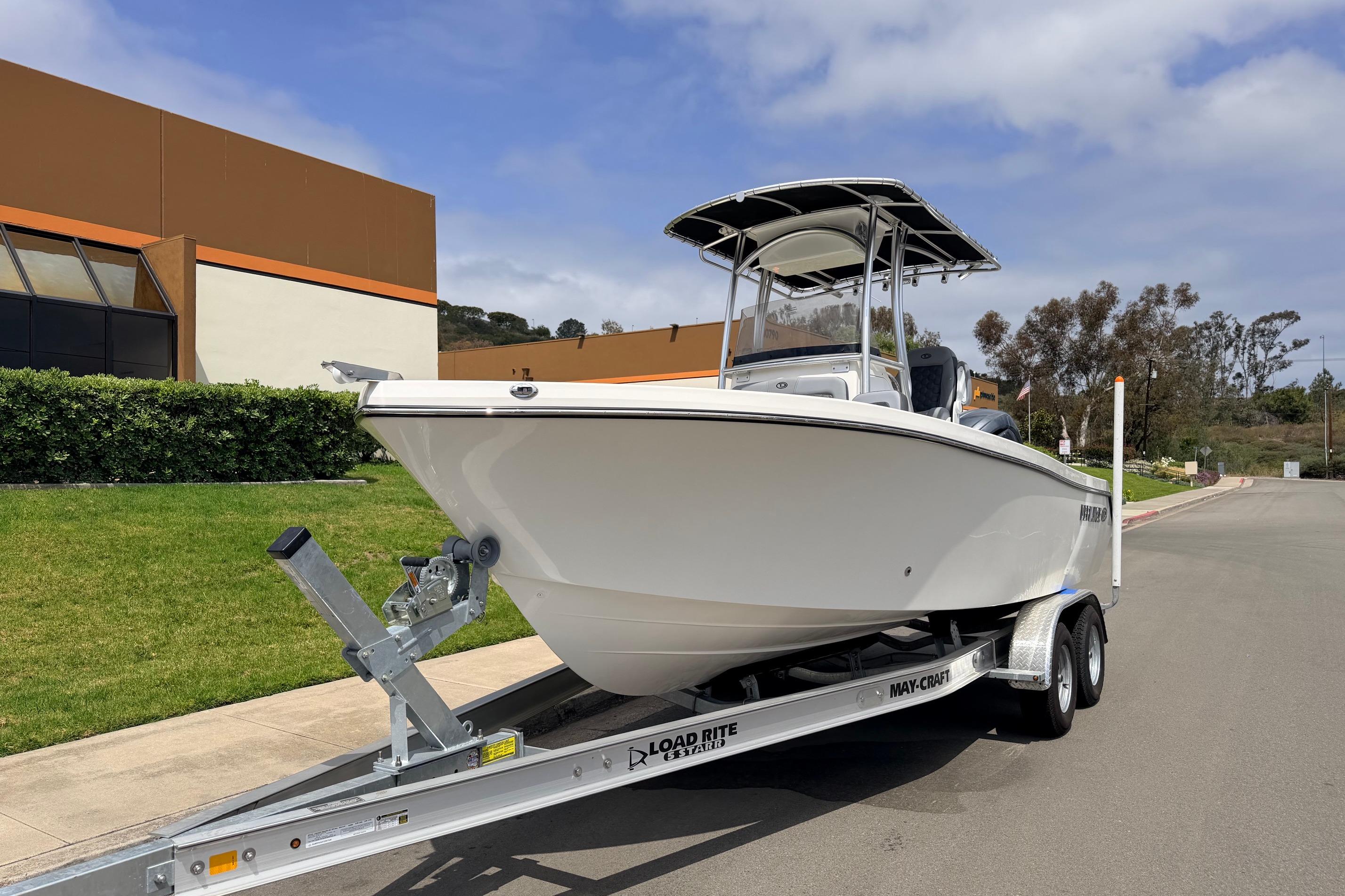 2026 Defiance Catalina 210 boat on trailer, parked outdoors near modern building.