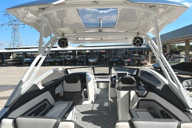 2021 Yamaha Boats 275SD interior with modern seating and sleek design under a clear sky.