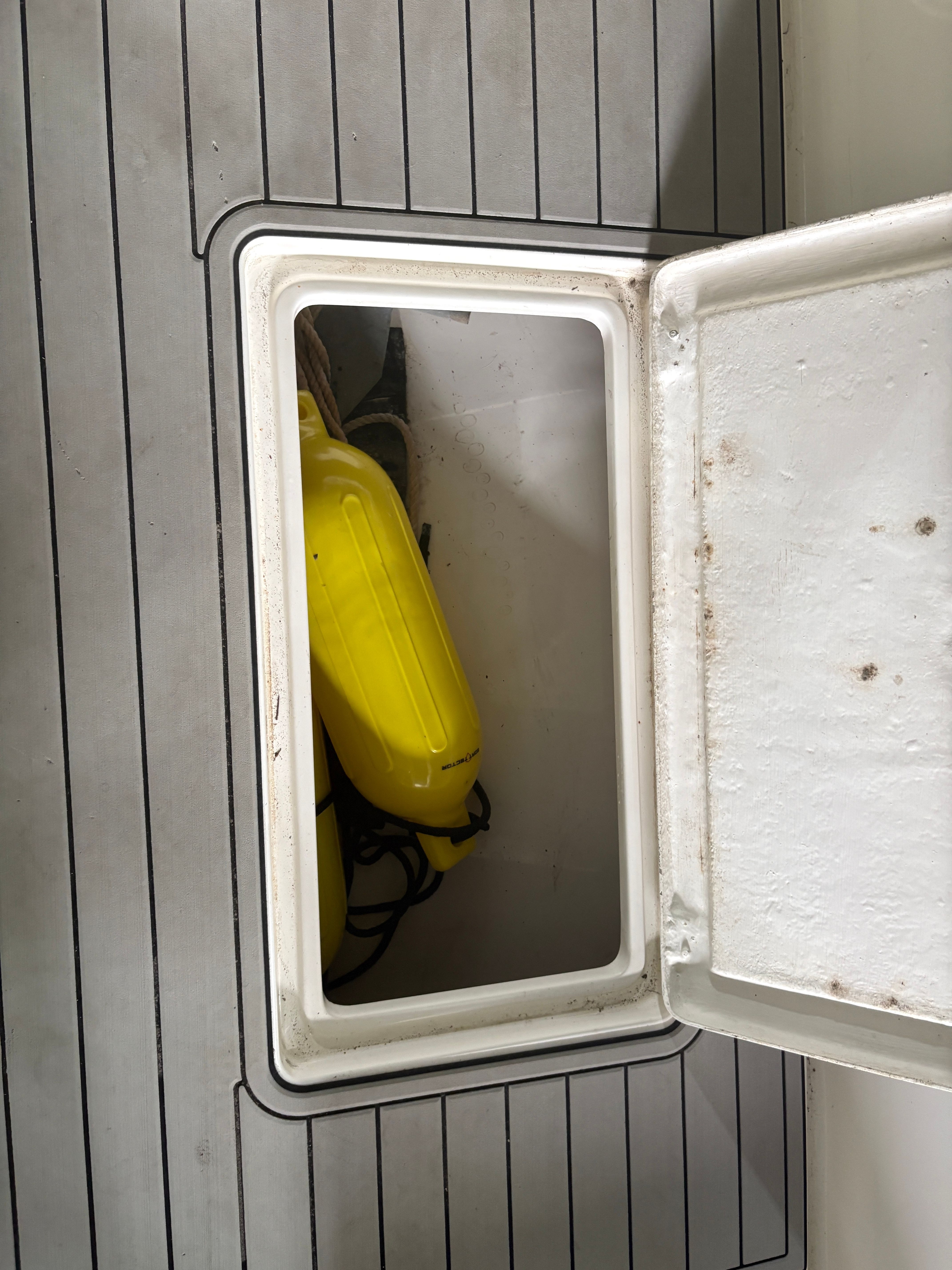 Open storage compartment on Intrepid 322 Cuddy Center Console boat.