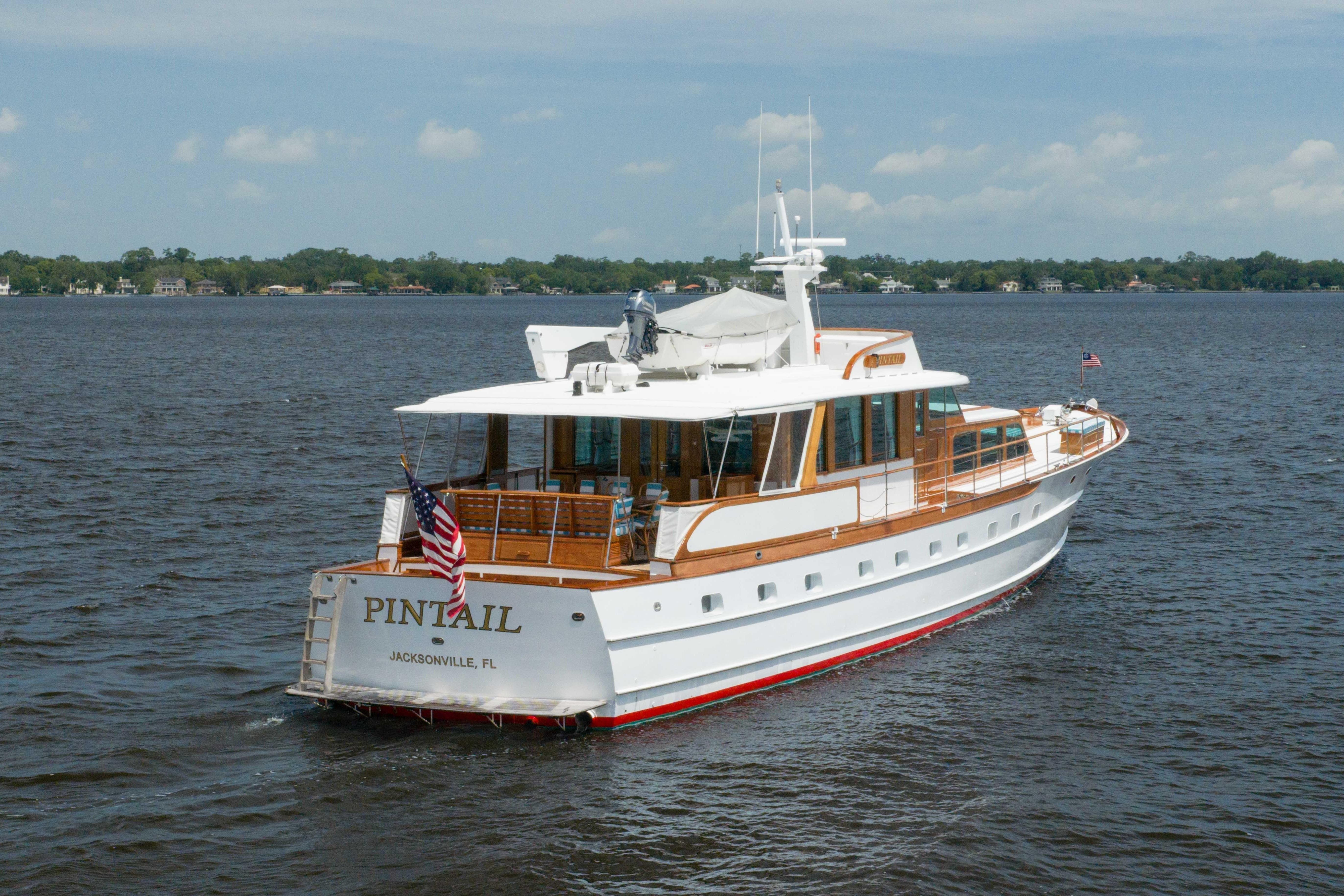 Classic 1963 Trumpy yacht "Pintail" cruising on a serene waterway, Jacksonville, FL.