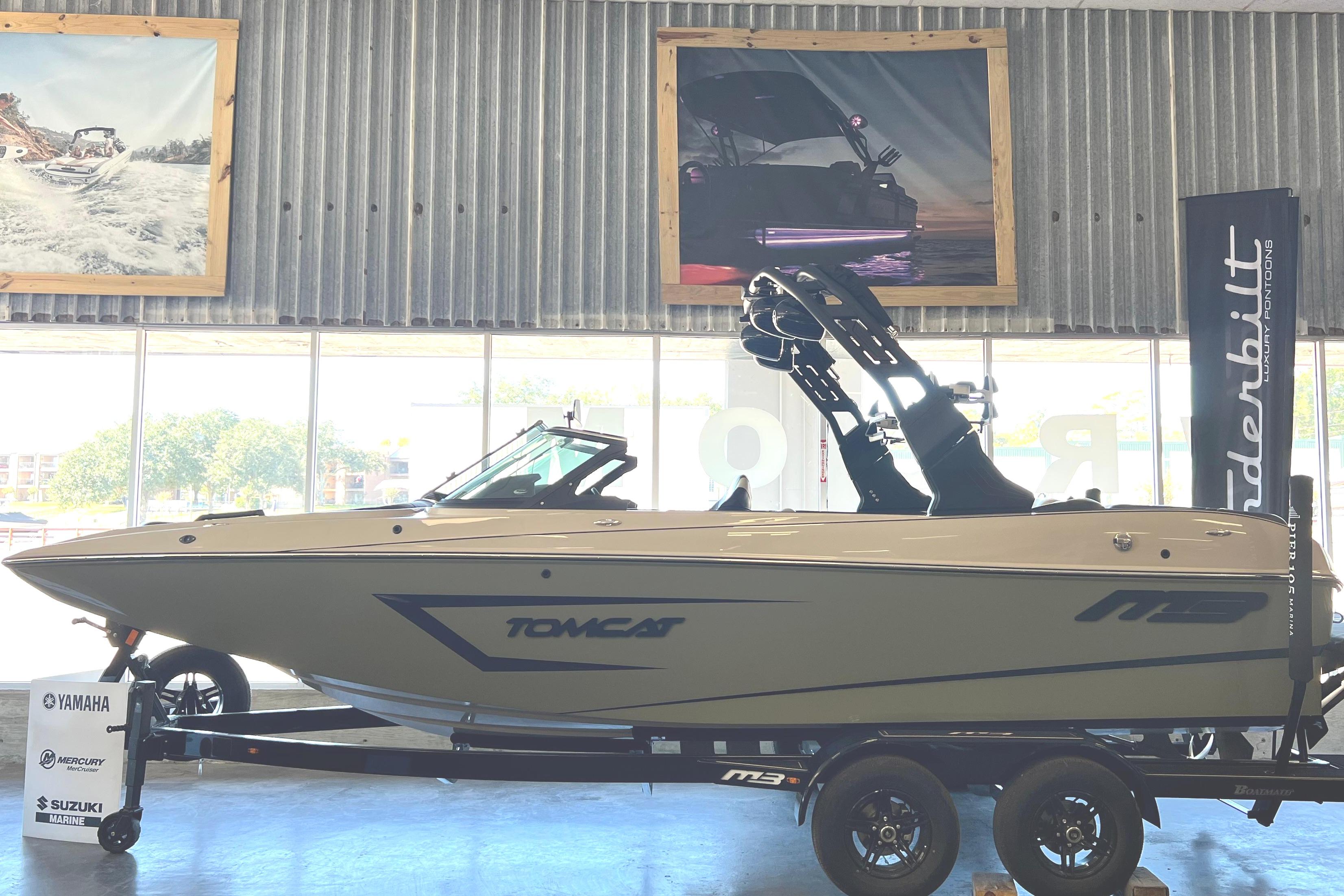 2024 MB F22 Tomcat boat on trailer in showroom.