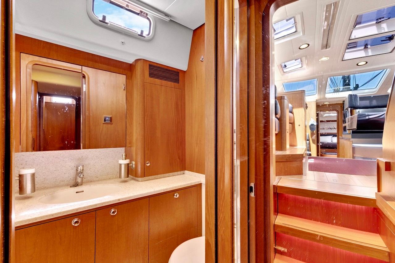 Luxurious interior of 2011 Southerly 57 RS yacht featuring wooden cabinetry and modern fixtures.