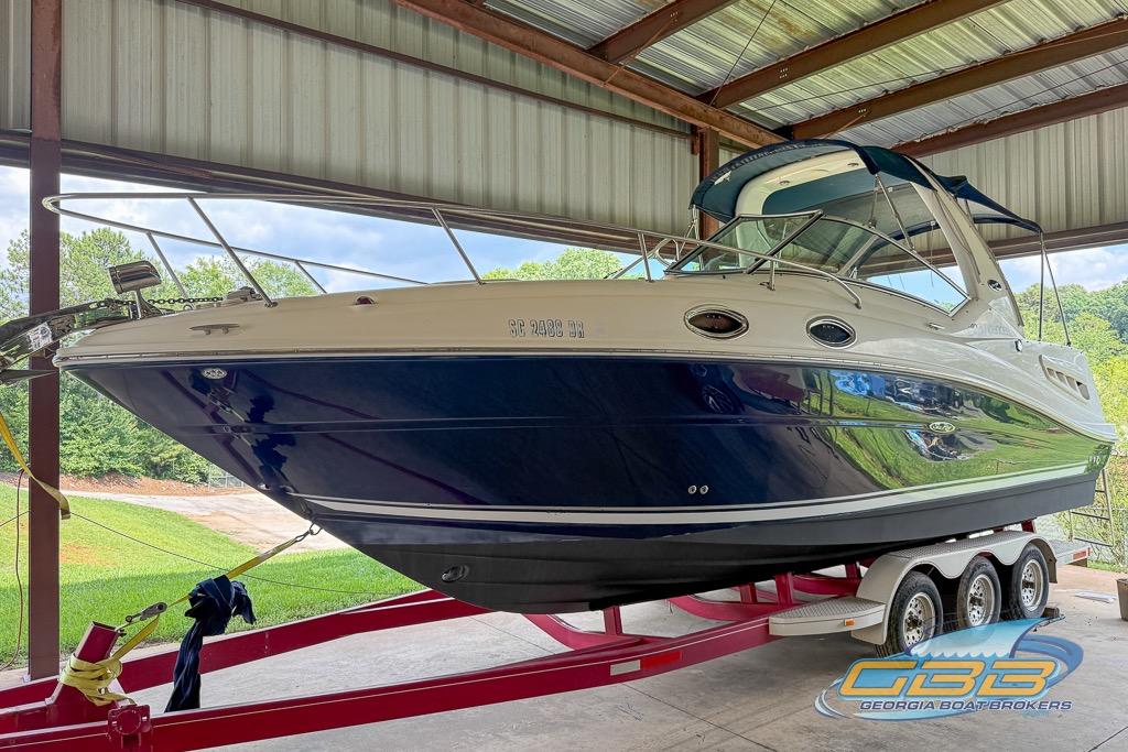 2006 Sea Ray Sundancer 260 on trailer in covered storage, Georgia Boat Brokers logo visible.
