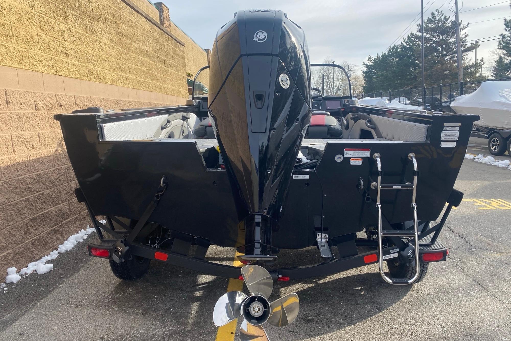 2026 Ranger VX1888 WT boat, rear view with outboard motor and ladder, parked outdoors.