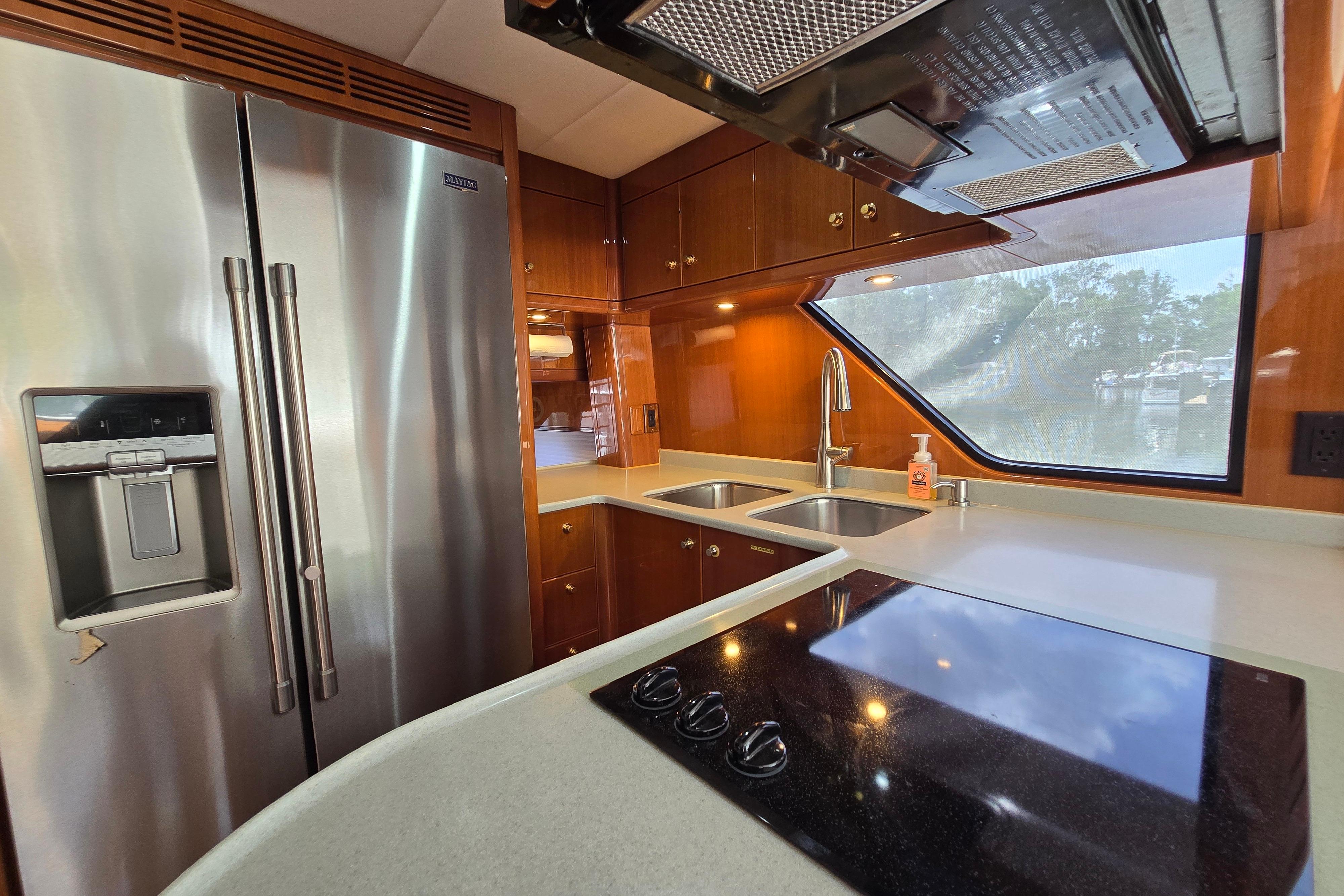 Luxurious yacht kitchen with stainless steel appliances, dual sinks, and modern fixtures, Grand Harbour 58, 2004.