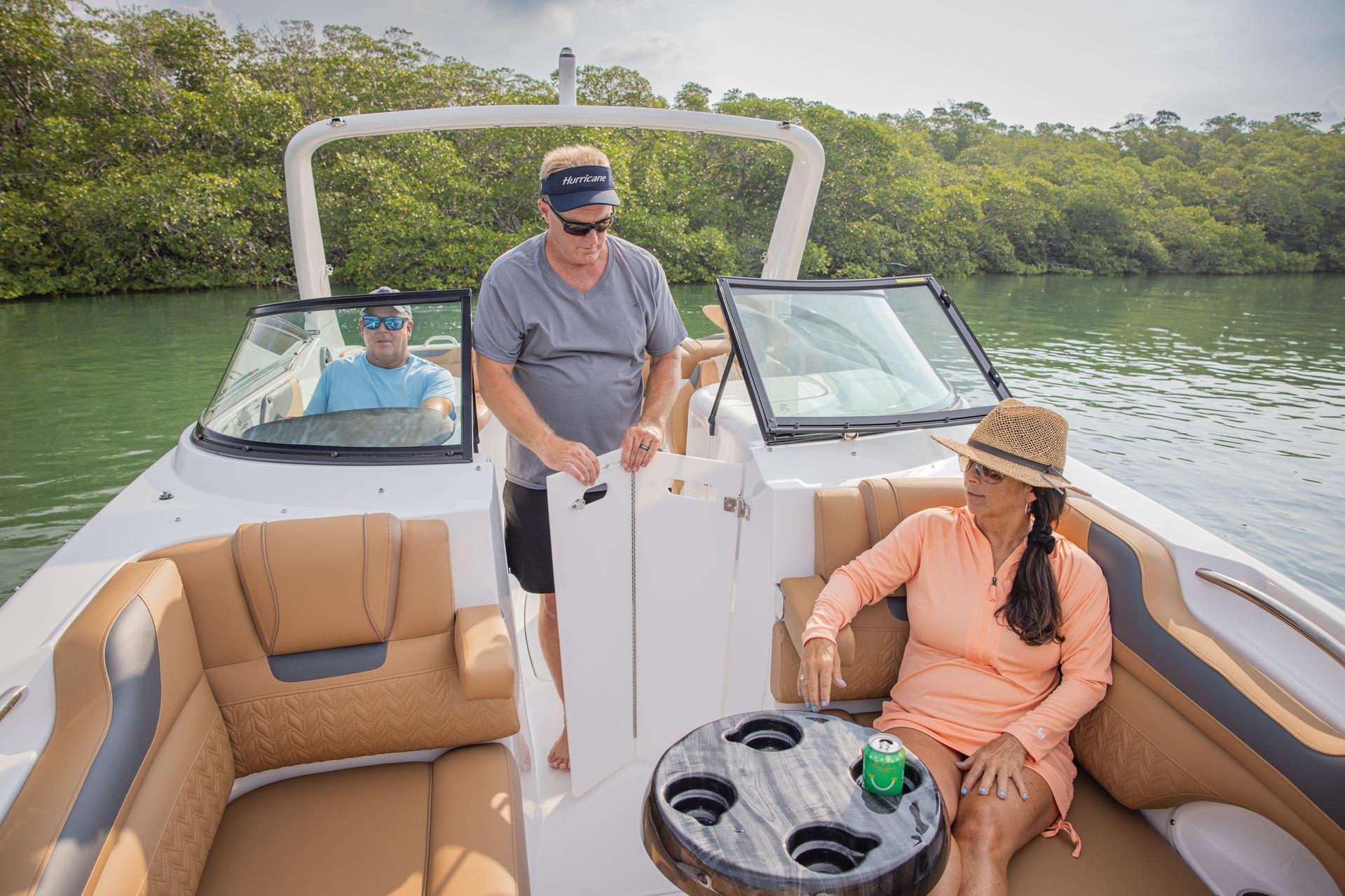 2026 Hurricane SunDeck 2690 OB boat with passengers enjoying a relaxing day on the water.