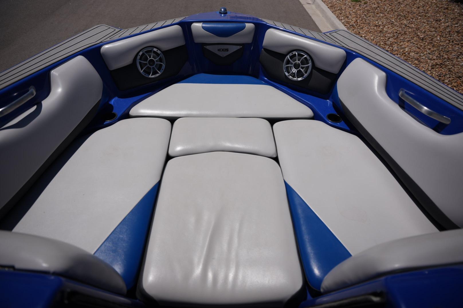 Interior of a 2015 Axis A24 boat with blue and white seating.