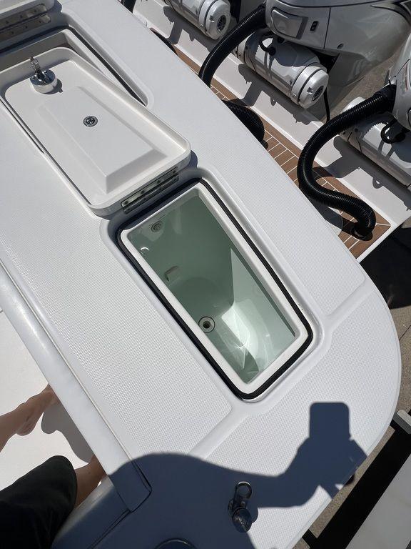 2021 Regulator 41 boat deck with storage compartments and engines.