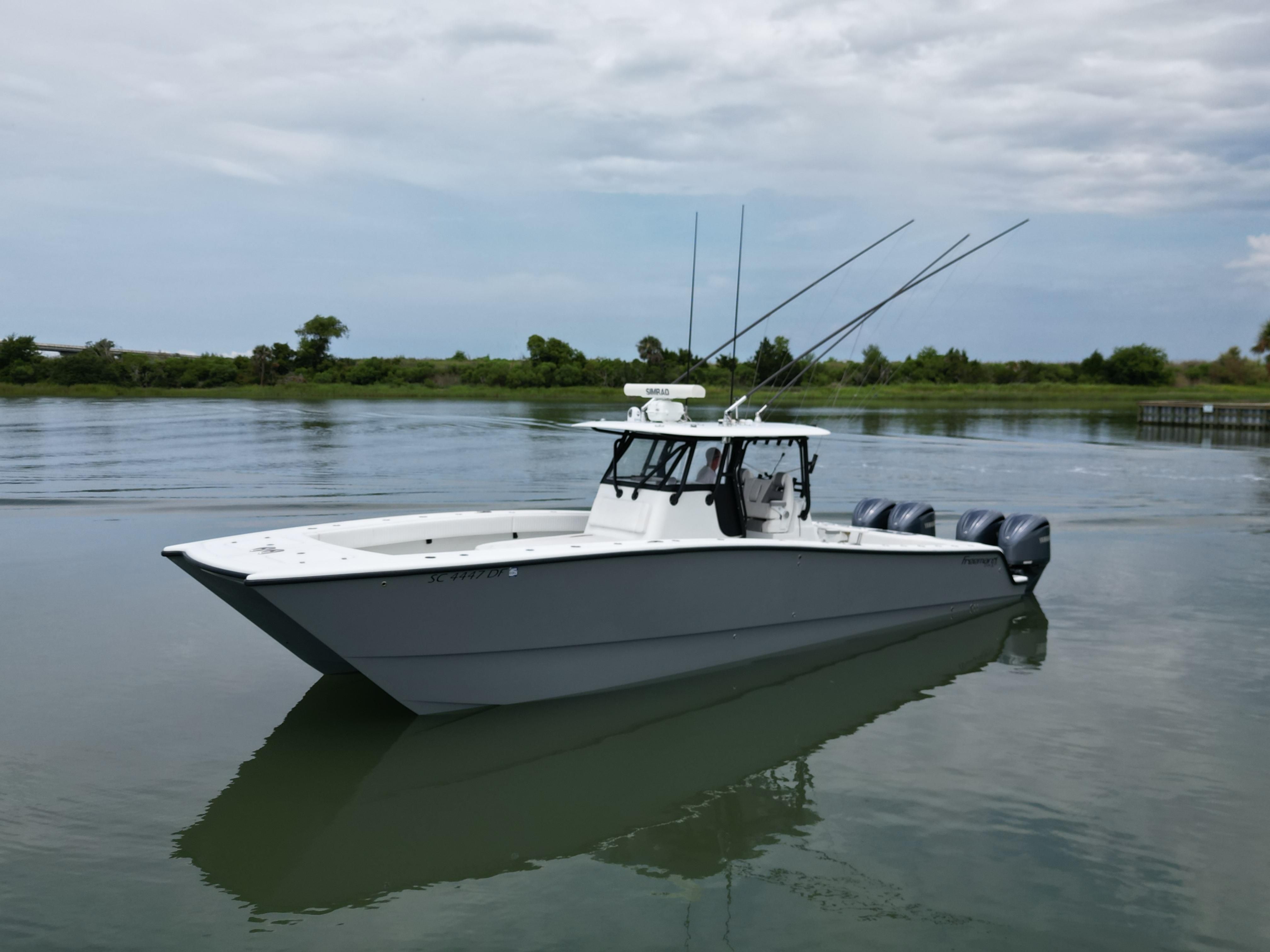 2017 Freeman 37VH boat on calm water with cloudy sky.