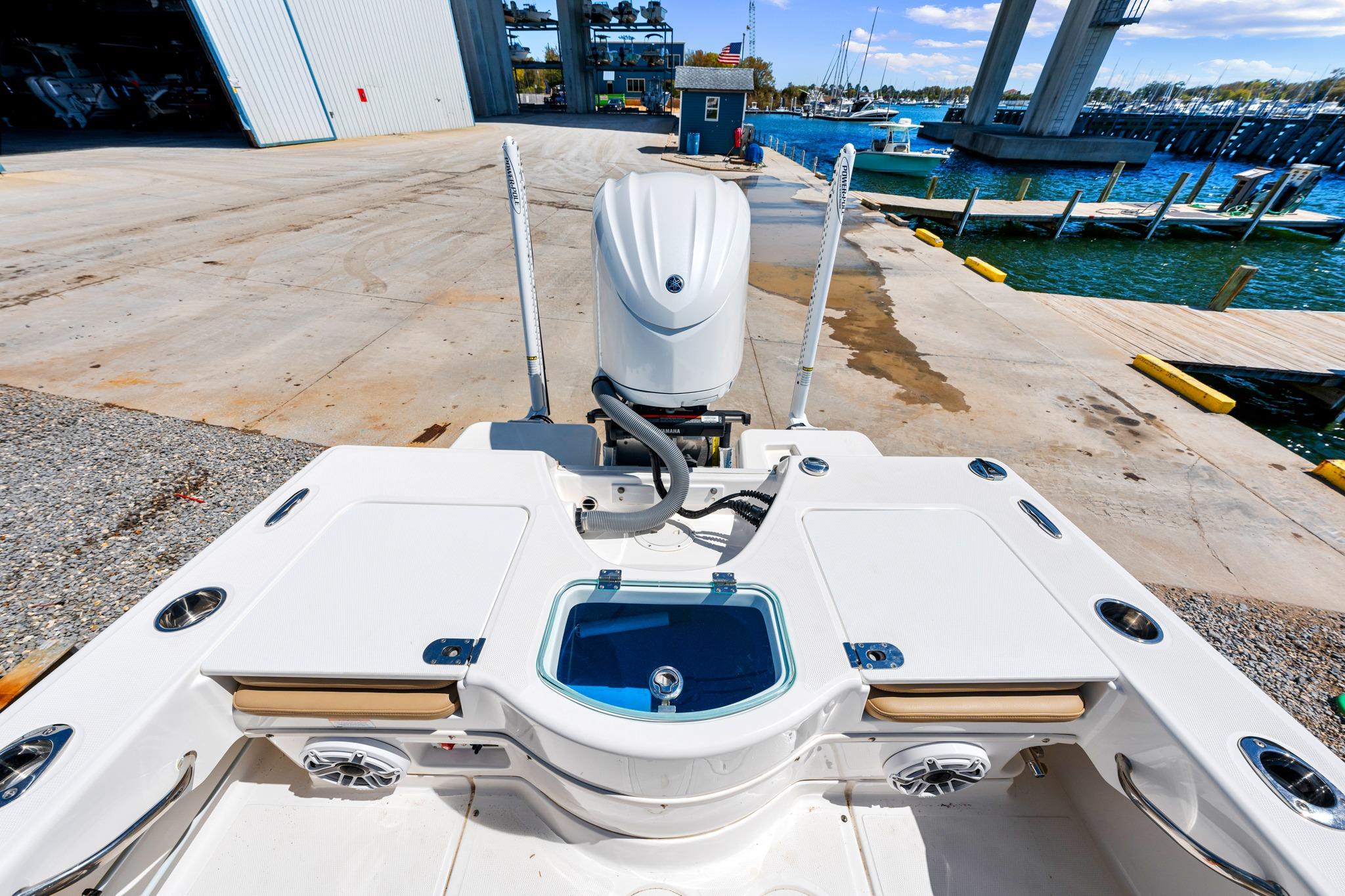 2023 Everglades 243 Center Console boat at dock, showcasing rear deck and engine.