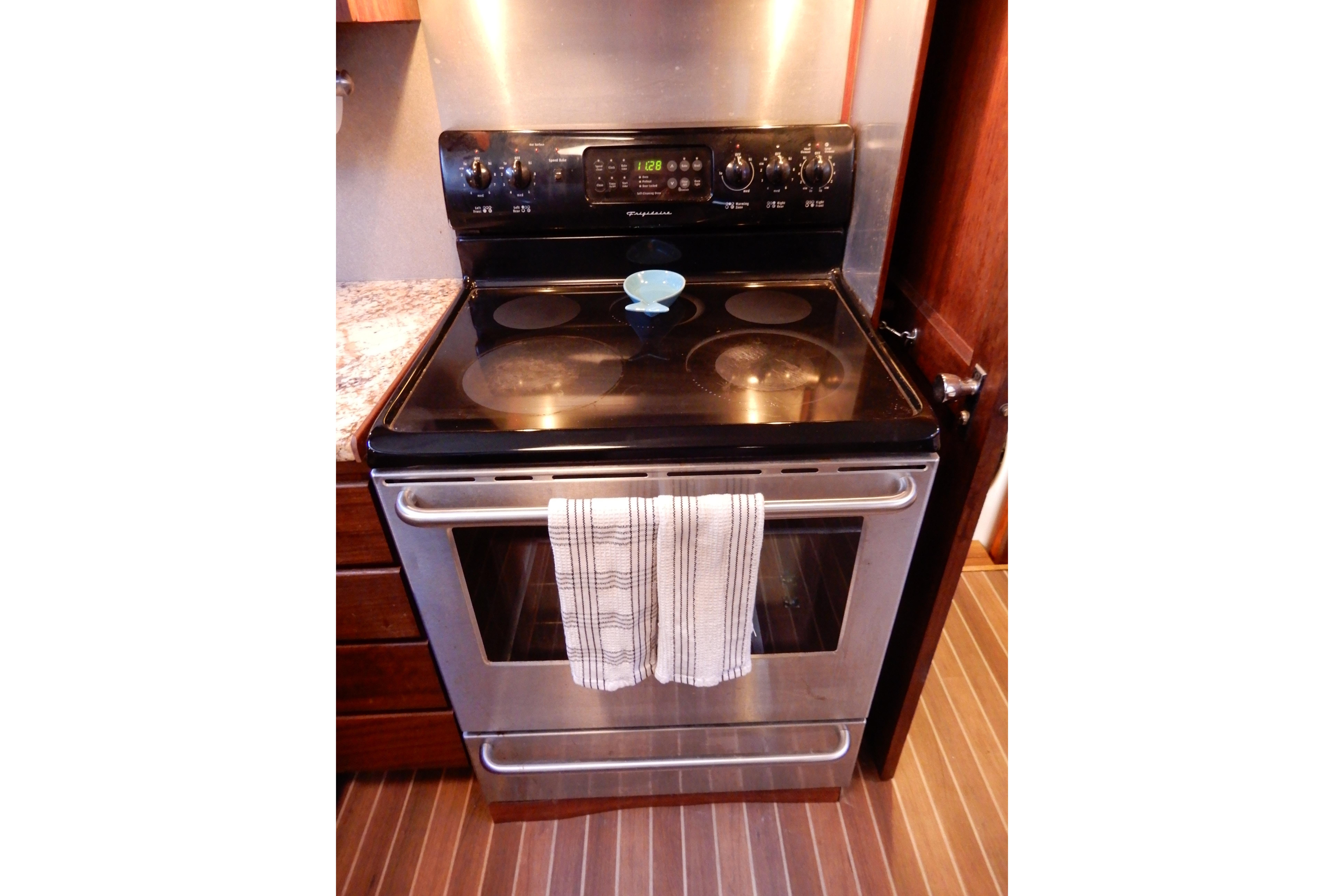 Stainless steel stove with towel in a 1974 Hatteras 53 Motor Yacht kitchen.