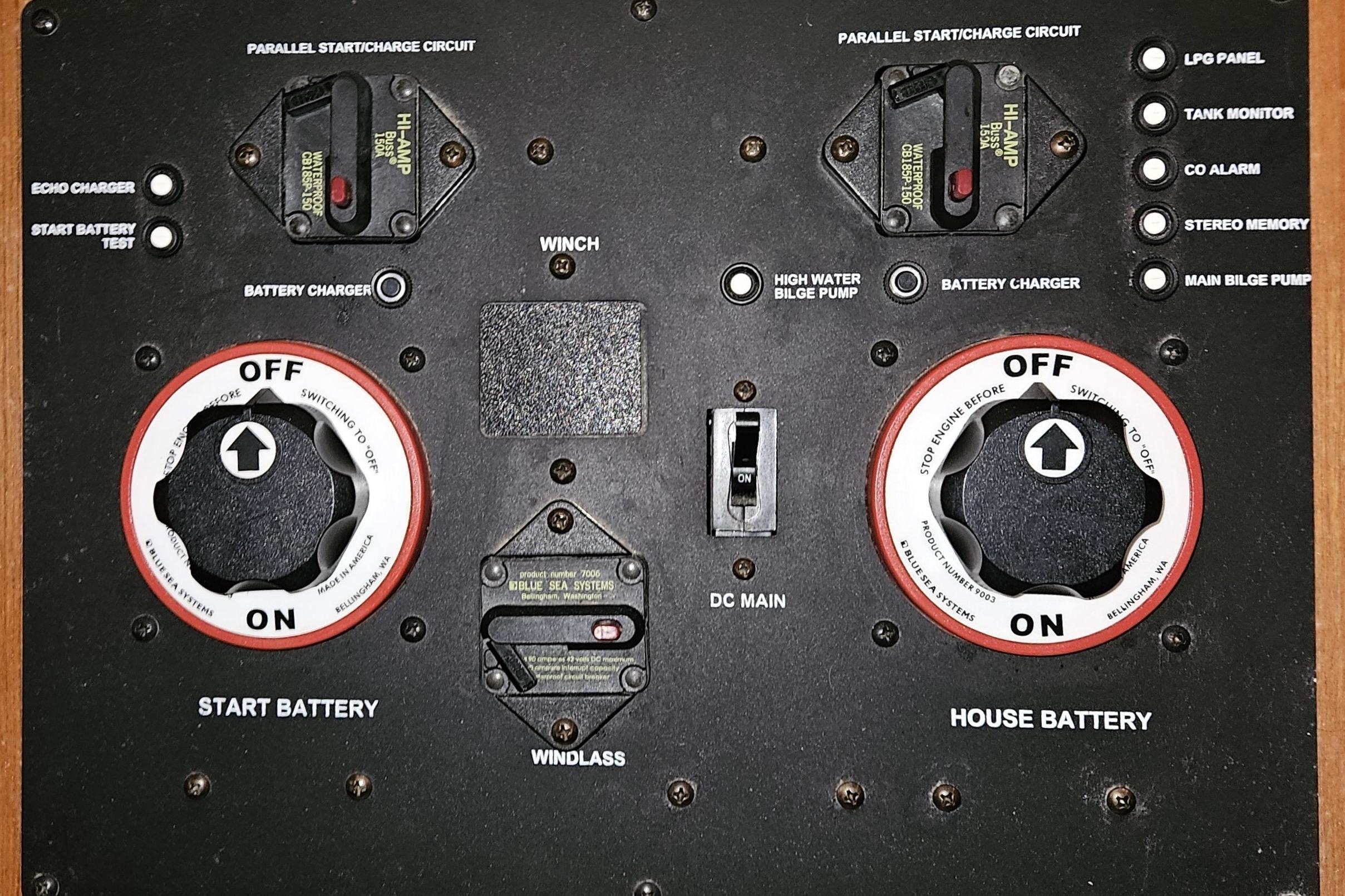 Control panel of a 2004 Hunter 386 sailboat with battery switches and circuit breakers.