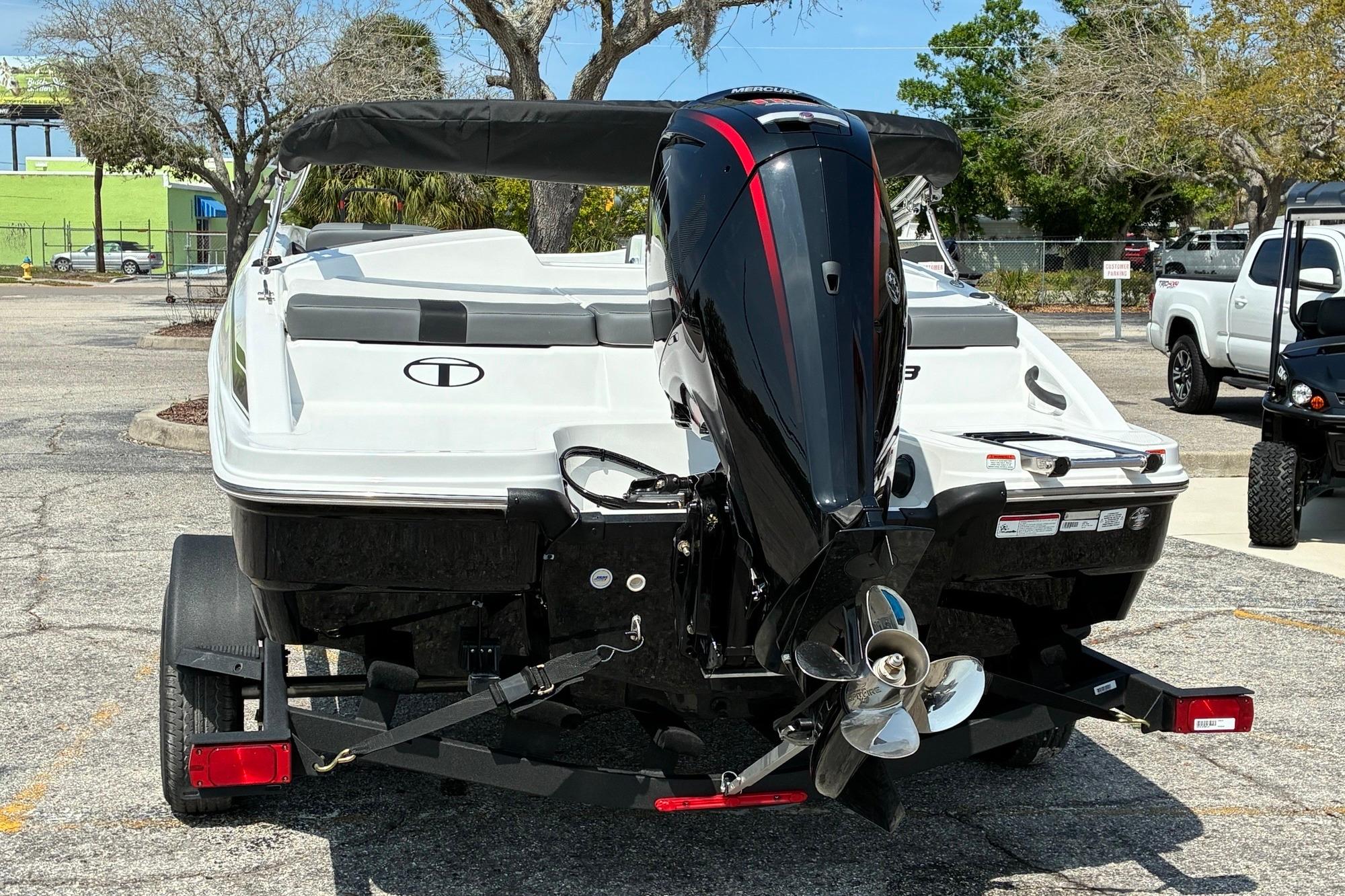 2026 Tahoe T18 boat on trailer with powerful outboard motor in parking lot.