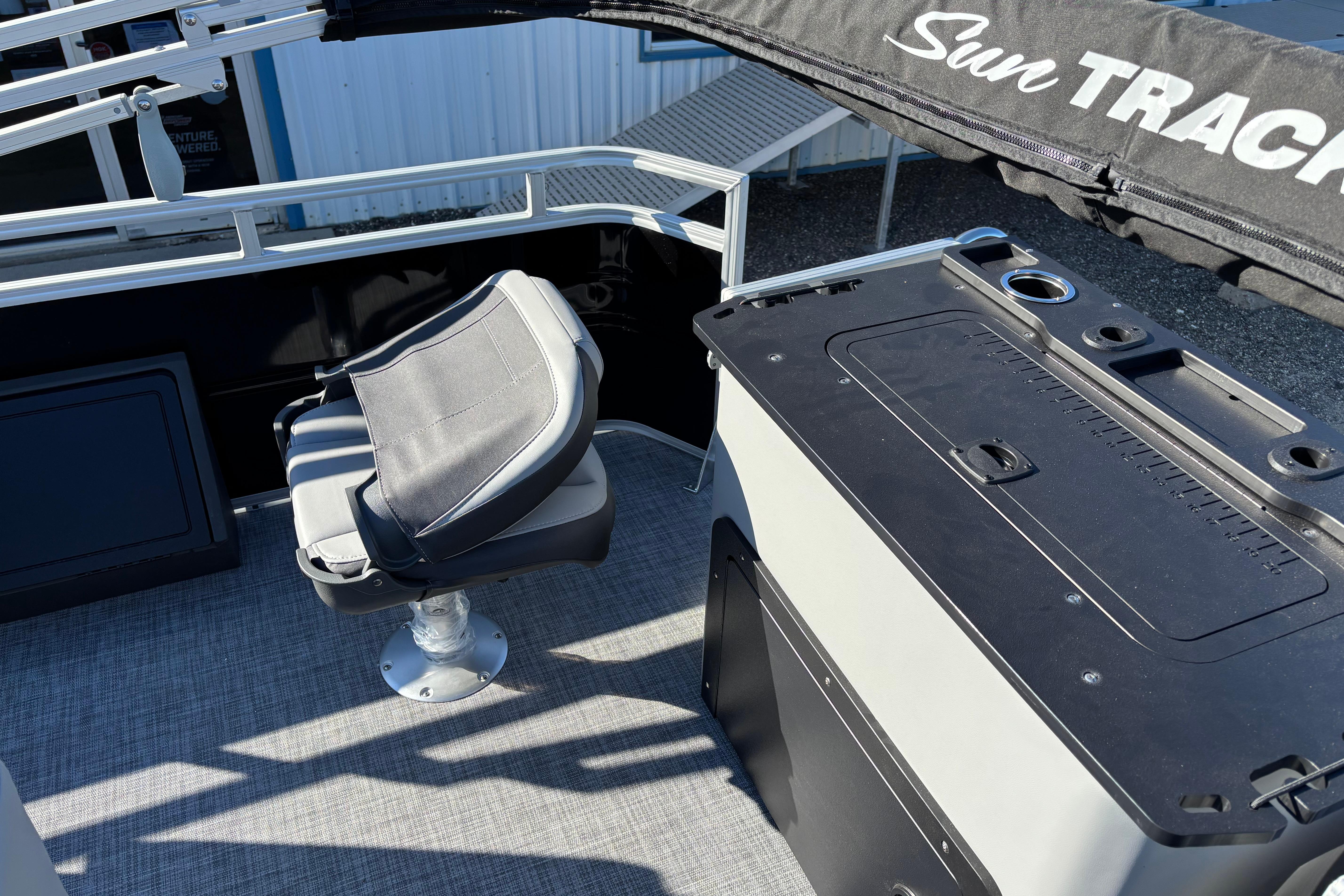 2026 Sun Tracker SportFish 22 XP3 interior with seating and storage area.