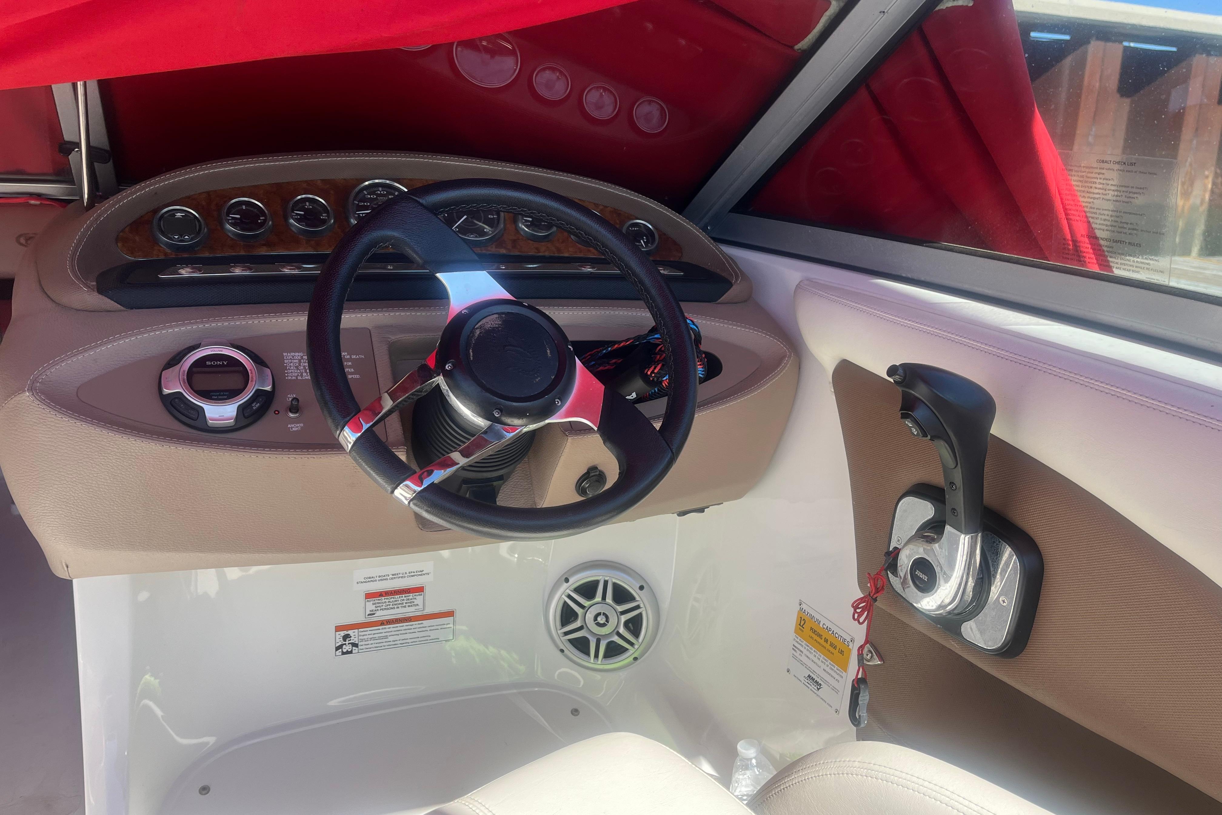 Interior of a 2011 Cobalt 210 boat showing steering wheel and control panel.