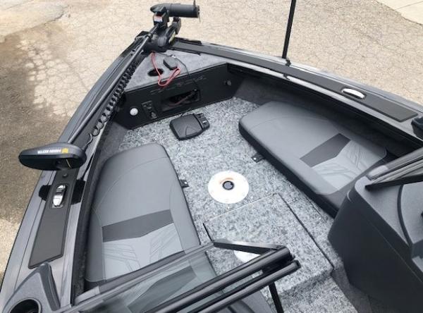 2025 Tracker Targa V18 Combo boat interior with gray seating and fishing equipment.