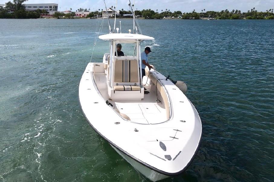 2008 Contender 36 Open boat cruising on clear blue water.