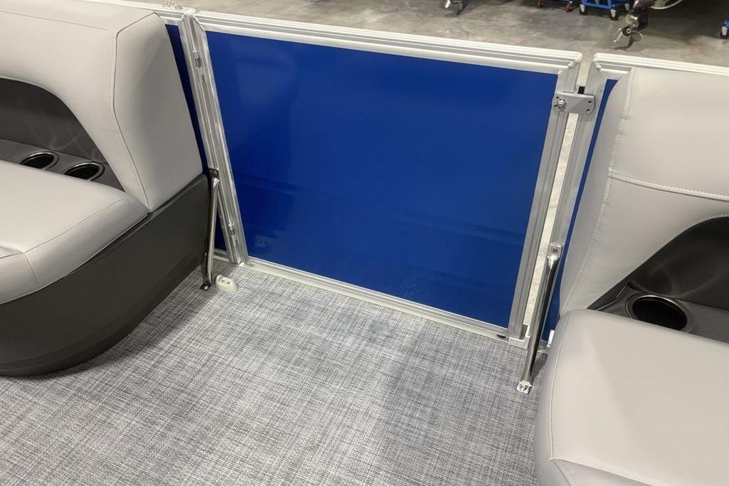2026 Sun Tracker Party Barge 16 DLX interior seating with blue panel and cup holders.